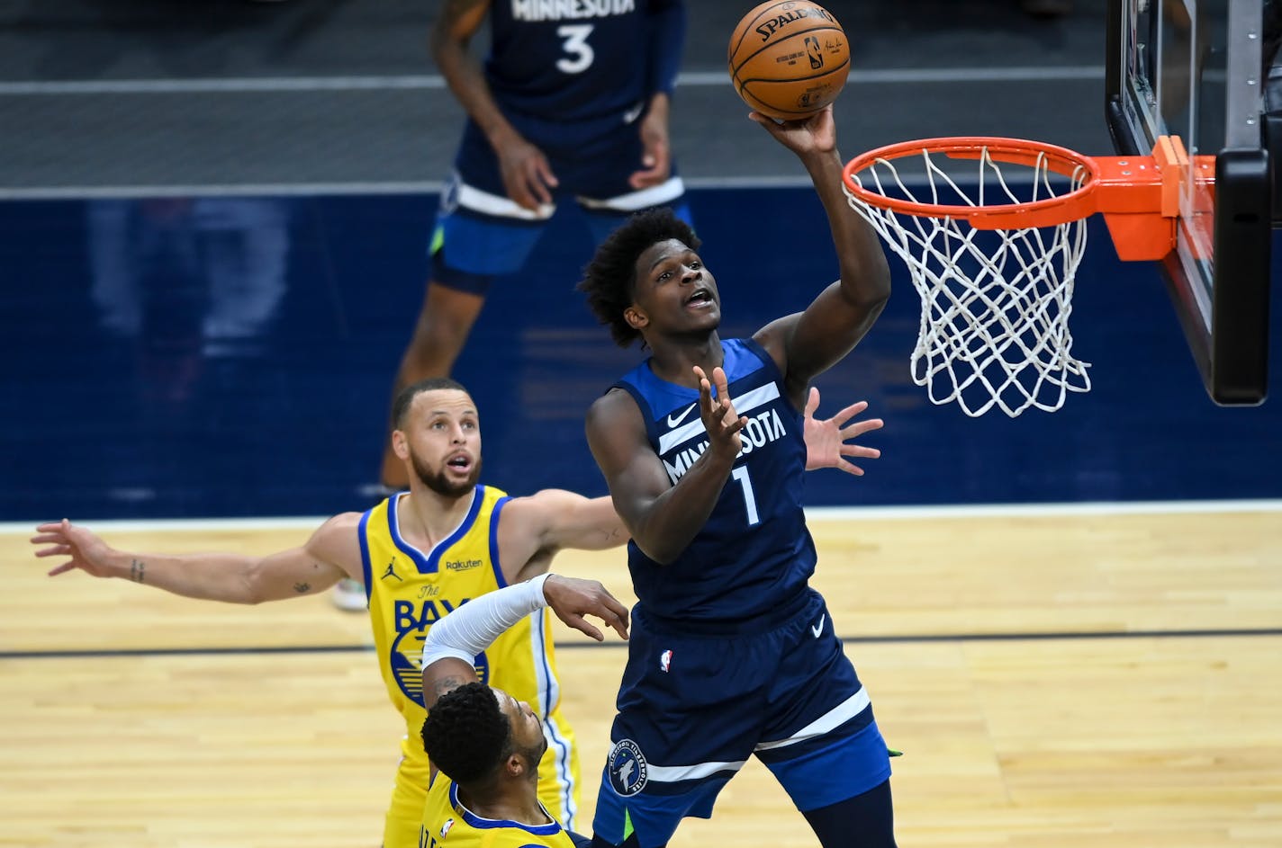 Minnesota Timberwolves forward Anthony Edwards (1) missed the layup but was fouled by Golden State Warriors guard Stephen Curry (30) for a chance at the free-throw line late in the fourth quarter.