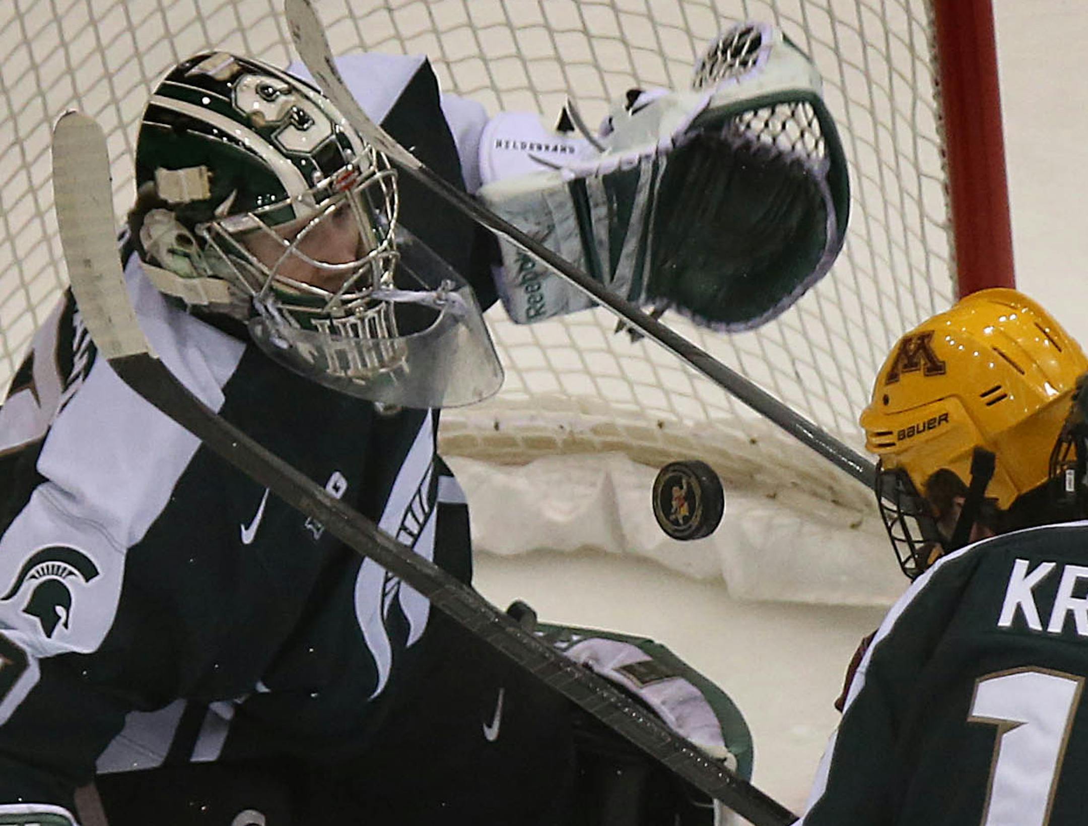 Michigan State goalie Jake Hildebrand concentrated on the puck while making a first period save against Minnesota‚Äôs Kyle Rau. ] JIM GEHRZ ‚Ä¢ jgehrz@startribune.com / Minneapolis, MN / January 31, 2014 / 8:00 PM BACKGROUND INFORMATION: The Minnesota Golden Gophers men‚Äôs hockey team played the Michigan State Spartans at Mariucci Arena in Big Ten hockey action.