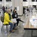 FILE - Election workers, right, verify ballots as recount observers, left, watch during a Milwaukee hand recount of presidential votes at the Wisconsi