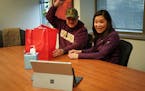 At their house closing, Mark Wollschlager and Julie Huang greeted Realtor Kath Hammerseng, who was available on a live video session on a portable ele