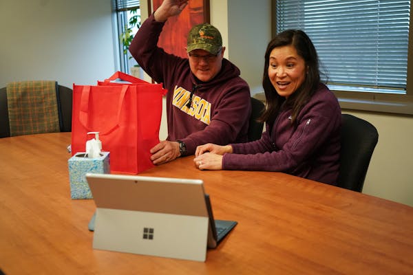 At their house closing, Mark Wollschlager and Julie Huang greeted Realtor Kath Hammerseng, who was available on a live video session on a portable ele