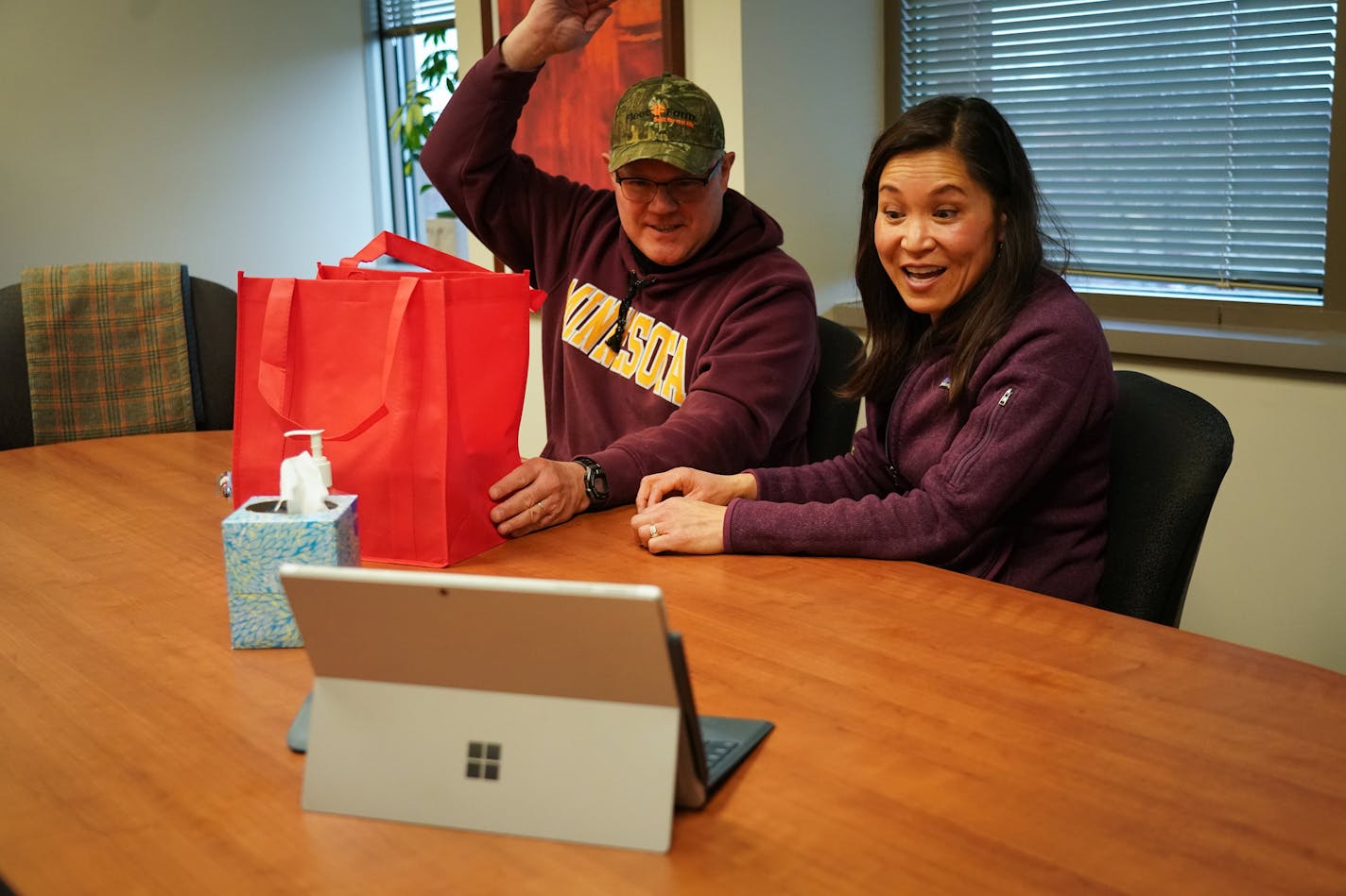 At their house closing, Mark Wollschlager and Julie Huang greeted Realtor Kath Hammerseng, who was available on a live video session on a portable electronic tablet.