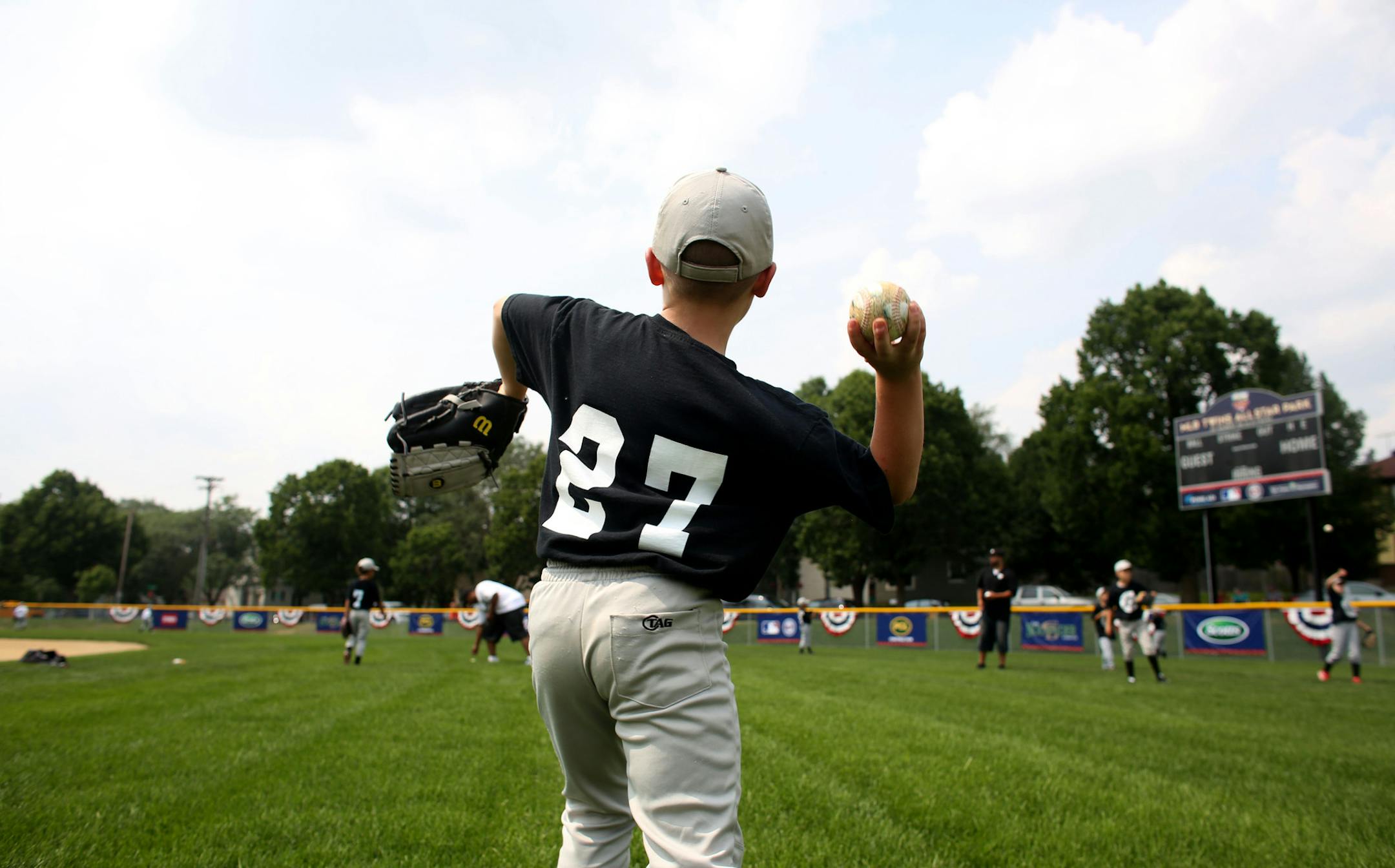 Vincent Volp, 8, of West Side Boosters team played catch with a teammate to warm up after the dedication ceremony. ] (KYNDELL HARKNESS/STAR TRIBUNE) kyndell.harkness@startribune.com At De La O Fields in St. Paul, Min. Thursday, July 9, 2014. Tony Oliva, Jim Pohlad and the widow of Roberto Clemente will be on hand Thursday afternoon to dedicate De La O Fields on St. Paul's West Side. The new baseball fields will give West Side kids a chance to play ball at a top notch facility, thanks to the Twin