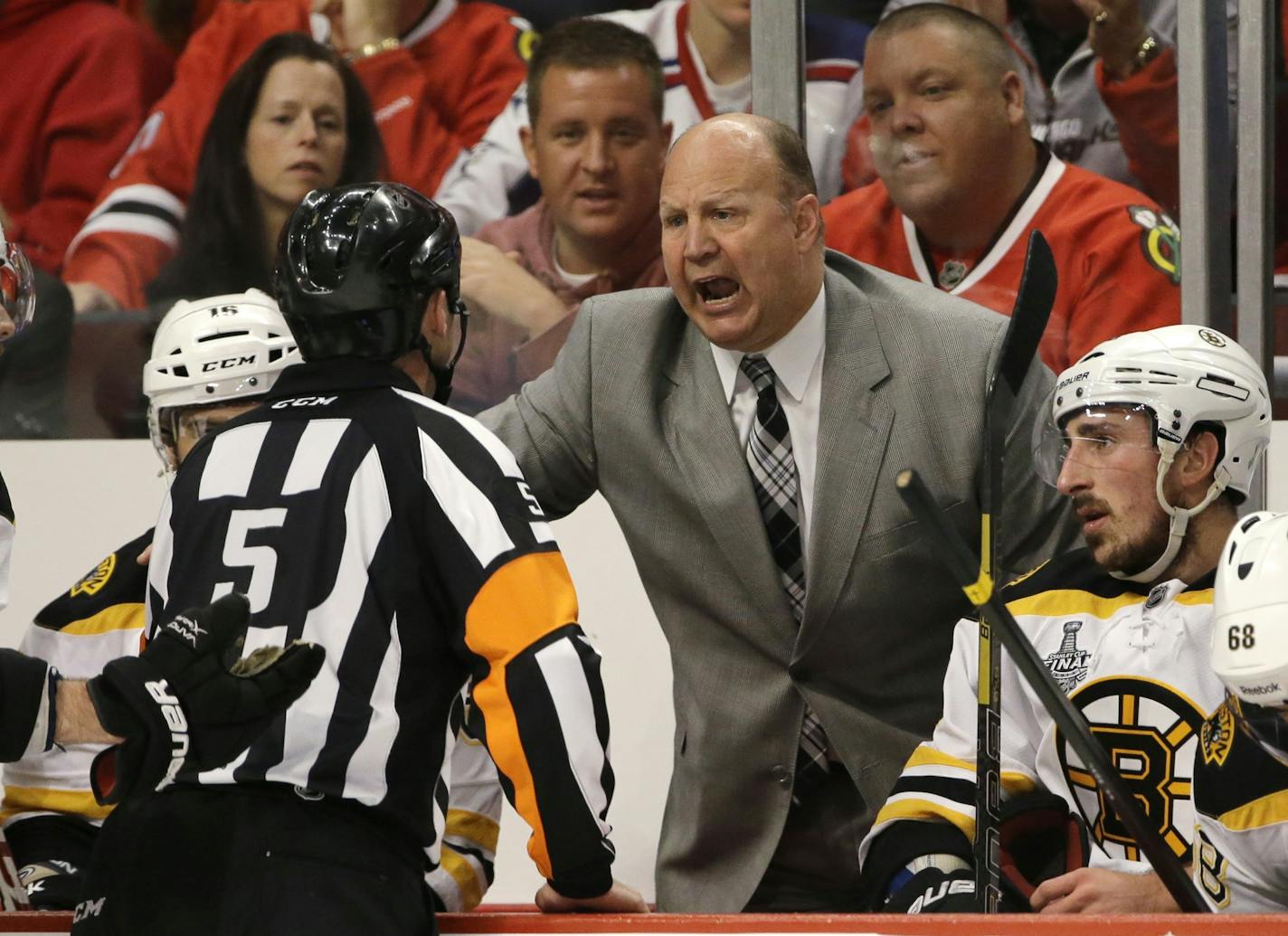 Boston Bruins head coach Claude Julien argues with an official (5) during the second period of Game 1 in their NHL Stanley Cup Final hockey series against the Chicago Blackhawks, Wednesday, June 12, 2013, in Chicago.