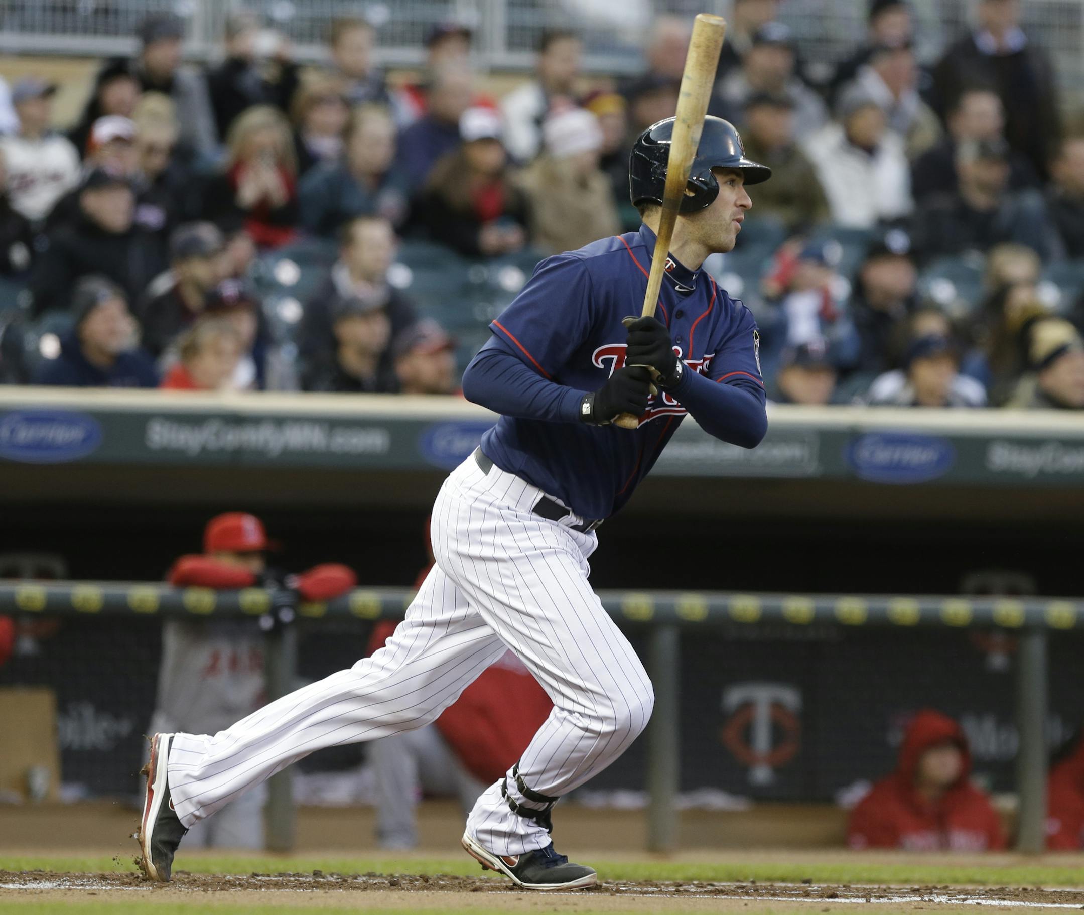 Minnesota Twins' Joe Mauer hits a single off Los Angeles Angels pitcher Jason Vargas in the first inning of a baseball game Tuesday, April 16, 2013 in Minneapolis. (AP Photo/Jim Mone)