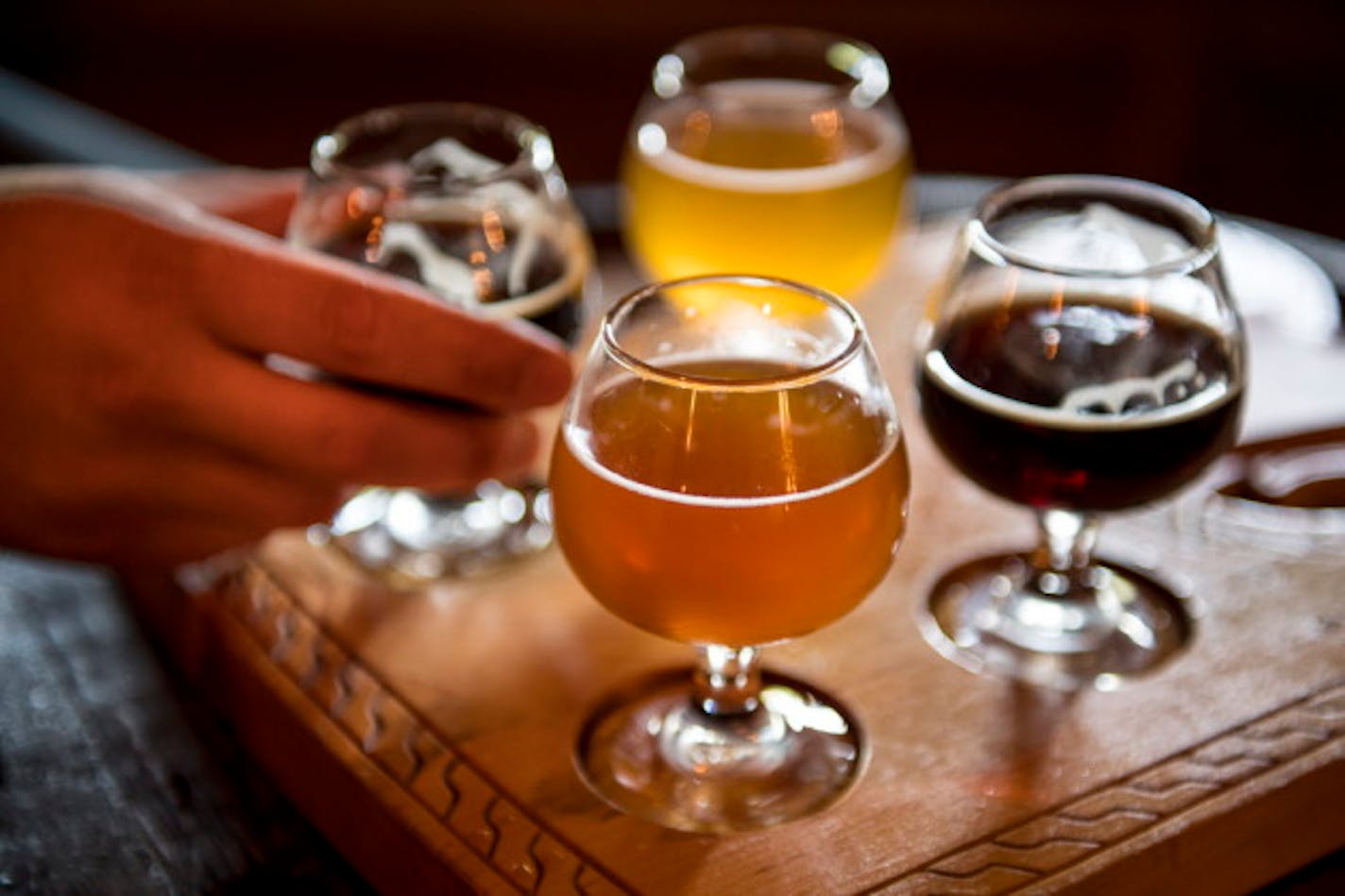 Chris Mikkelsen (CQ), of Mayer, grabbed a glass of Dunkelwald Saturday at Hammerheart Brewing's taproom. ] (AARON LAVINSKY/STAR TRIBUNE) aaron.lavinsky@startribune.com Photos to accompany a feature on craft beer taprooms. Photographed Saturday, June 25, 2016 in White Bear Lake and Lino Lakes.