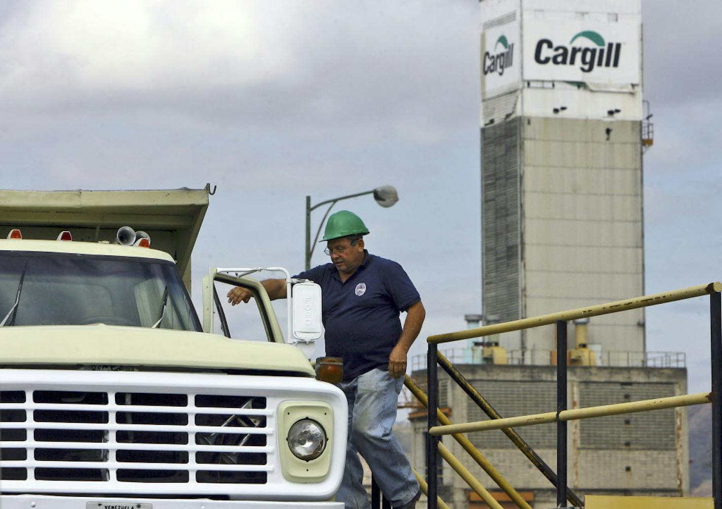 A man walks next to his truck at a vegetable oil factory owned by American food giant Cargill Inc., in Valencia, Venezuela, Thursday, March 5, 2009. Venezuela's President Hugo Chavez ordered Wednesday the expropriation of a rice-processing plant owned by Cargill because the company allegedly was not distributing rice at prices imposed by the government. (AP Photo/Juan Carlos Hernandez) ORG XMIT: XFLL104