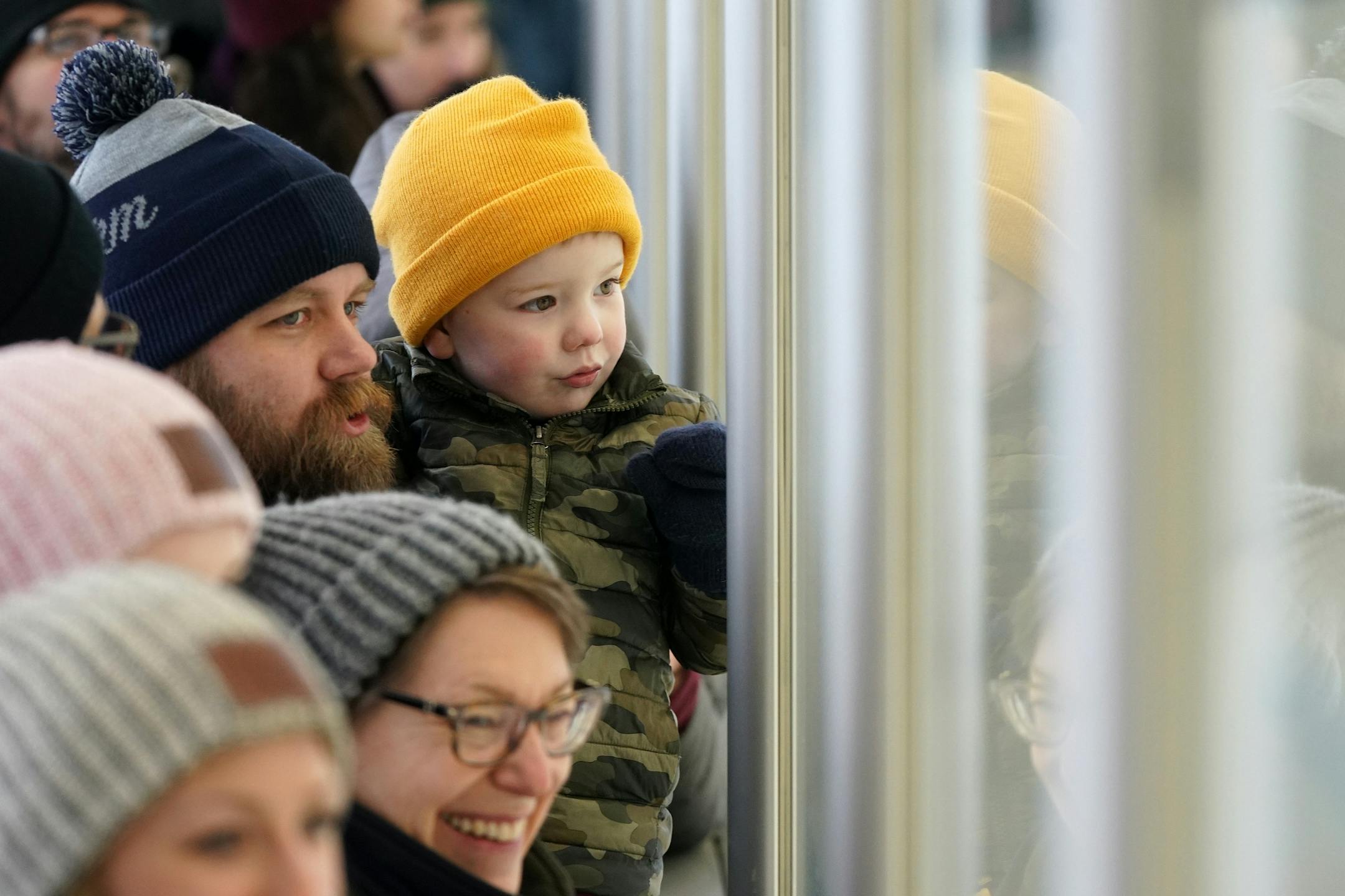 Anders Dybdahl of St. Louis Park held his son Caleb, 3, as they watched through the glass during the Wild's outdoor practice Thursday.