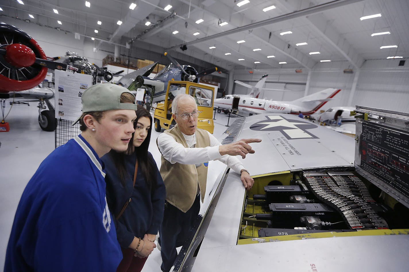 Bob Jasperson, Director of the Wings of the North Air Museum, showed Chaska Integrated Arts Academy students Andy Germond, left, and Izzy Bruesh, center, the 1945 combat vet P-51 Mustang Sierra Sue II, at the museum, Friday, January 20, 2017 in Eden Prairie, MN. ] (ELIZABETH FLORES/STAR TRIBUNE) ELIZABETH FLORES &#x2022; eflores@startribune.com