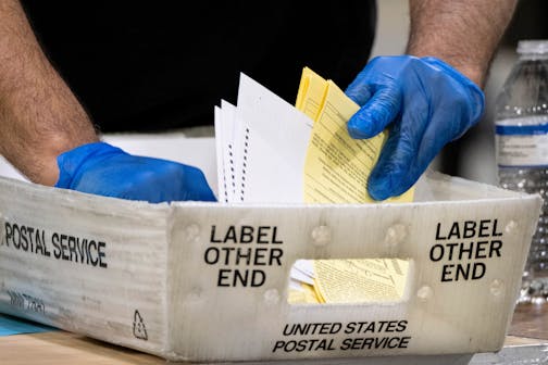 Fulton County Georgia elections workers process absentee ballots for the Senate runoff election in Atlanta on Tuesday, Jan. 5, 2021. Georgia's two Senate runoff elections on Tuesday will determine which party controls the U.S. Senate. Republican Kelly Loeffler is going up against Democrat Raphael Warnock, while Republican David Perdue is challenging Democrat Jon Ossoff.