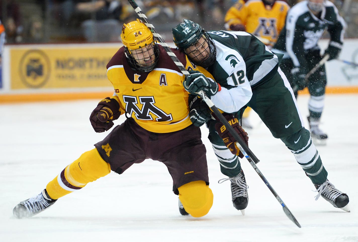 Minnesota Golden Gophers right wing Hudson Fasching (24) and Michigan State Spartans forward Ryan Keller (12) collided while chasing down the puck in the third period. ] (AARON LAVINSKY/STAR TRIBUNE) aaron.lavinsky@startribune.com The University of Minnesota Golden Gophers mens' hockey team played the Michigan State University Spartans on Saturday, Jan. 16, 2016 at Mariucci Arena in Minneapolis, Minn.