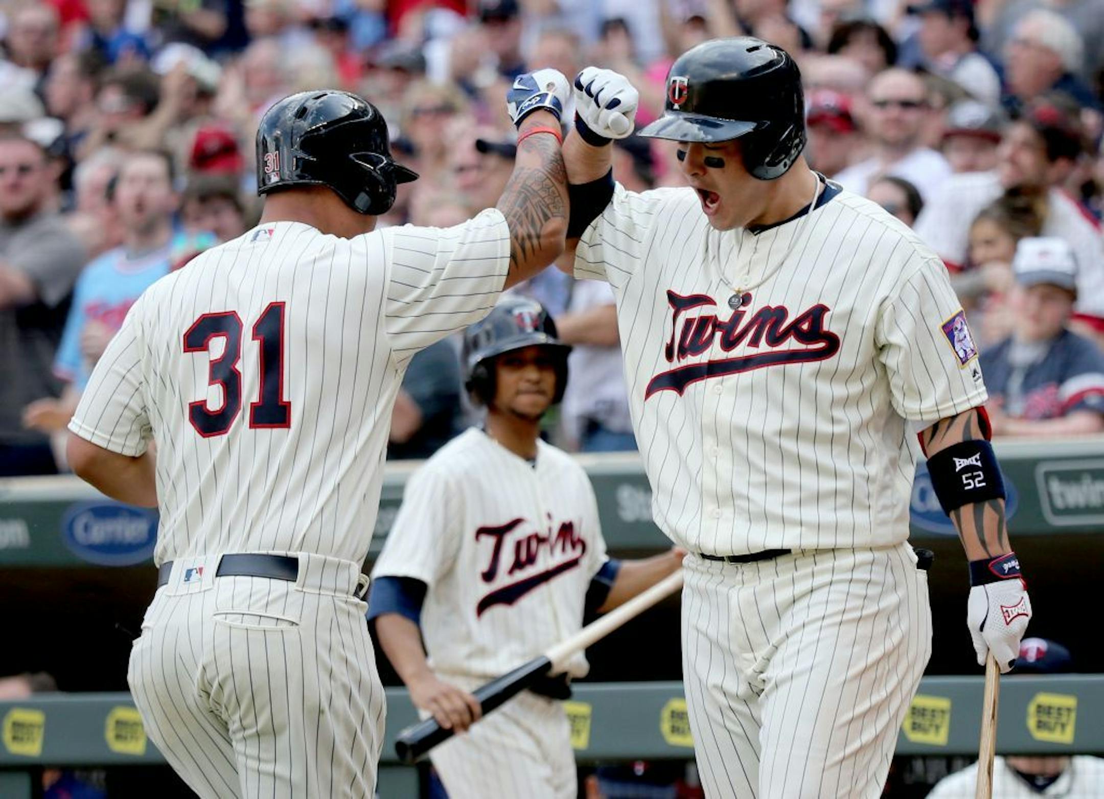 The Minnesota Twins Oswaldo Arcia, left, is greeted by teammate Byung Ho Park after Arcia homered to give the Twins the lead in the 8th inning. Park then followed with a homer and Minnesota beat Los Angeles Angels 6-4 Saturday, April 16, 2016, at Target Field in Minneapolis, MN.