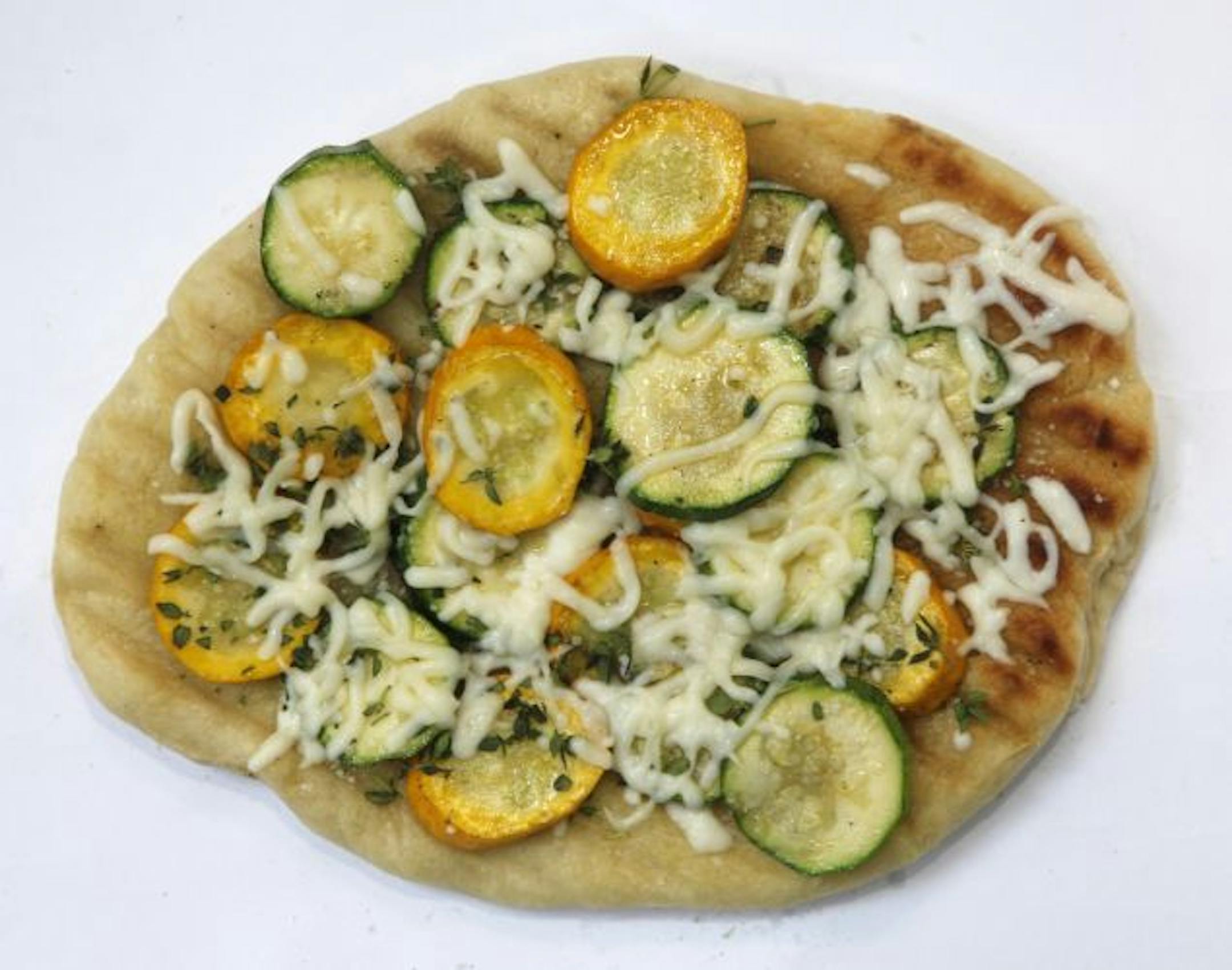 Pizza with olive oil, grilled zucchini, thyme and mozzarella.