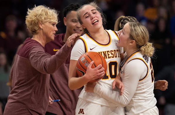 Gophers guard Katie Borowicz (23) celebrated with guard Mara Braun (10) after her game-winning shot as time ran out in the fourth quarter of their gam