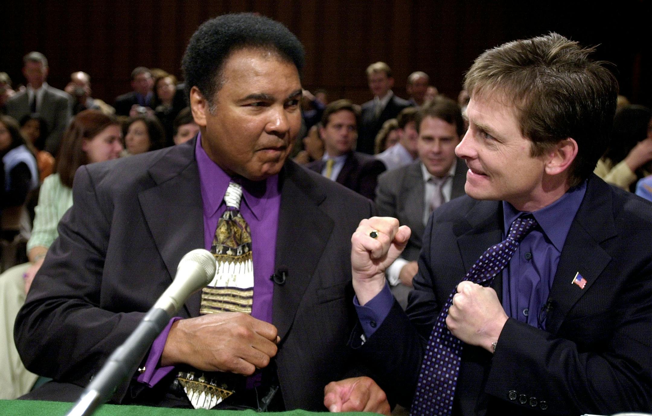 Boxing legend Muhammad Ali, left, and actor Michael J. Fox joke around on Capitol Hill in this May 22, 2002, file photo before the start of a Senate Labor subcommittee hearing on Parkinson's Disease. Witness lists for congressional hearings in recent months have started to resemble Hollywood's list of who's who: Julia Roberts, Christie Brinkley and Michael J. Fox. Sen. George Voinovich, R-Ohio, says he's tired of Congress using celebrities to drum up media attention.