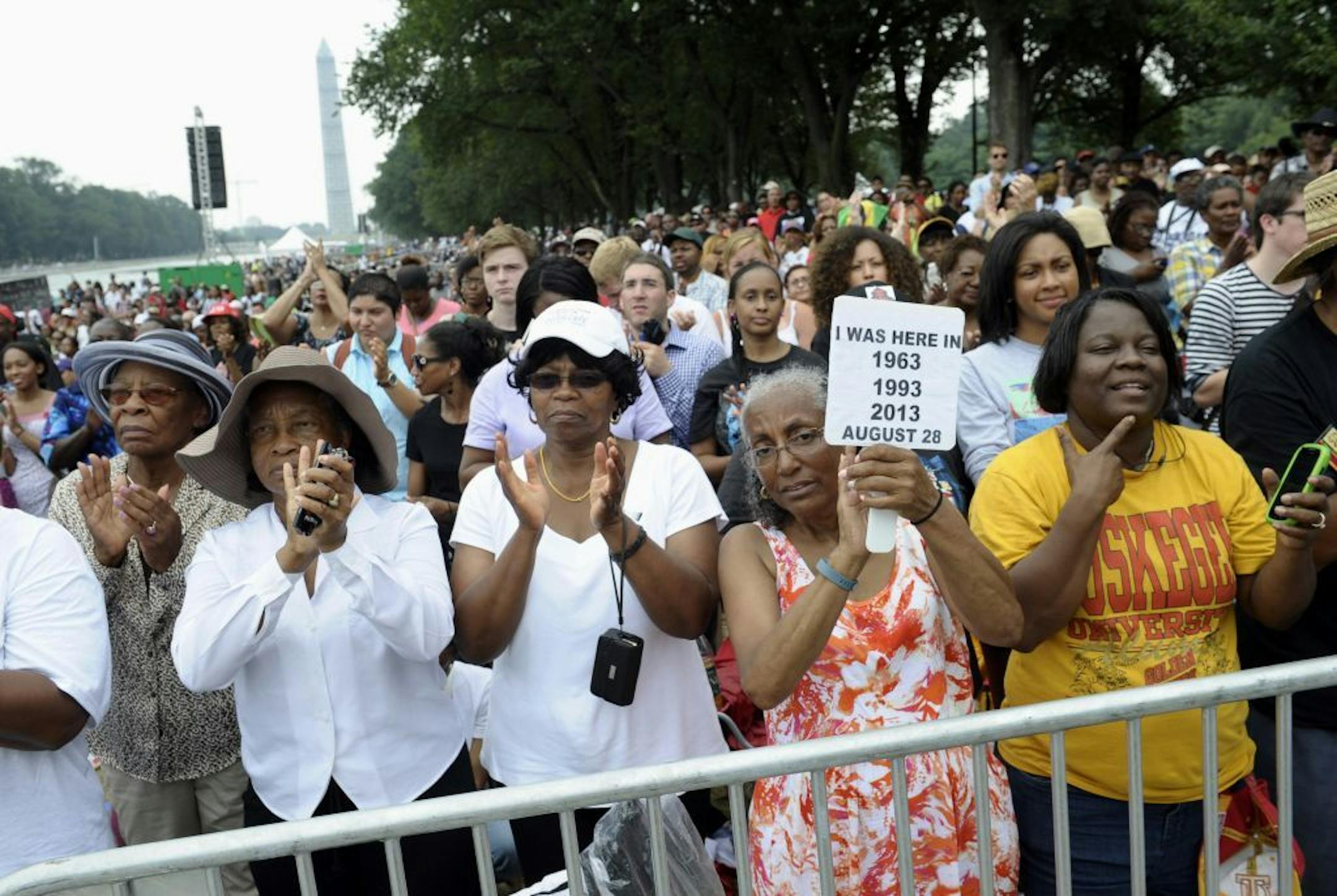 Three women who attended previous March's on Washington, from left, Armanda Hawkins of Memphis, Vera Moore of Washington, and Betty Waller Gray of Richmond, Va., (holding sign) listen to the speakers during the March on Washington, Wednesday, Aug. 28, 2013, at the Lincoln Memorial in Washington.