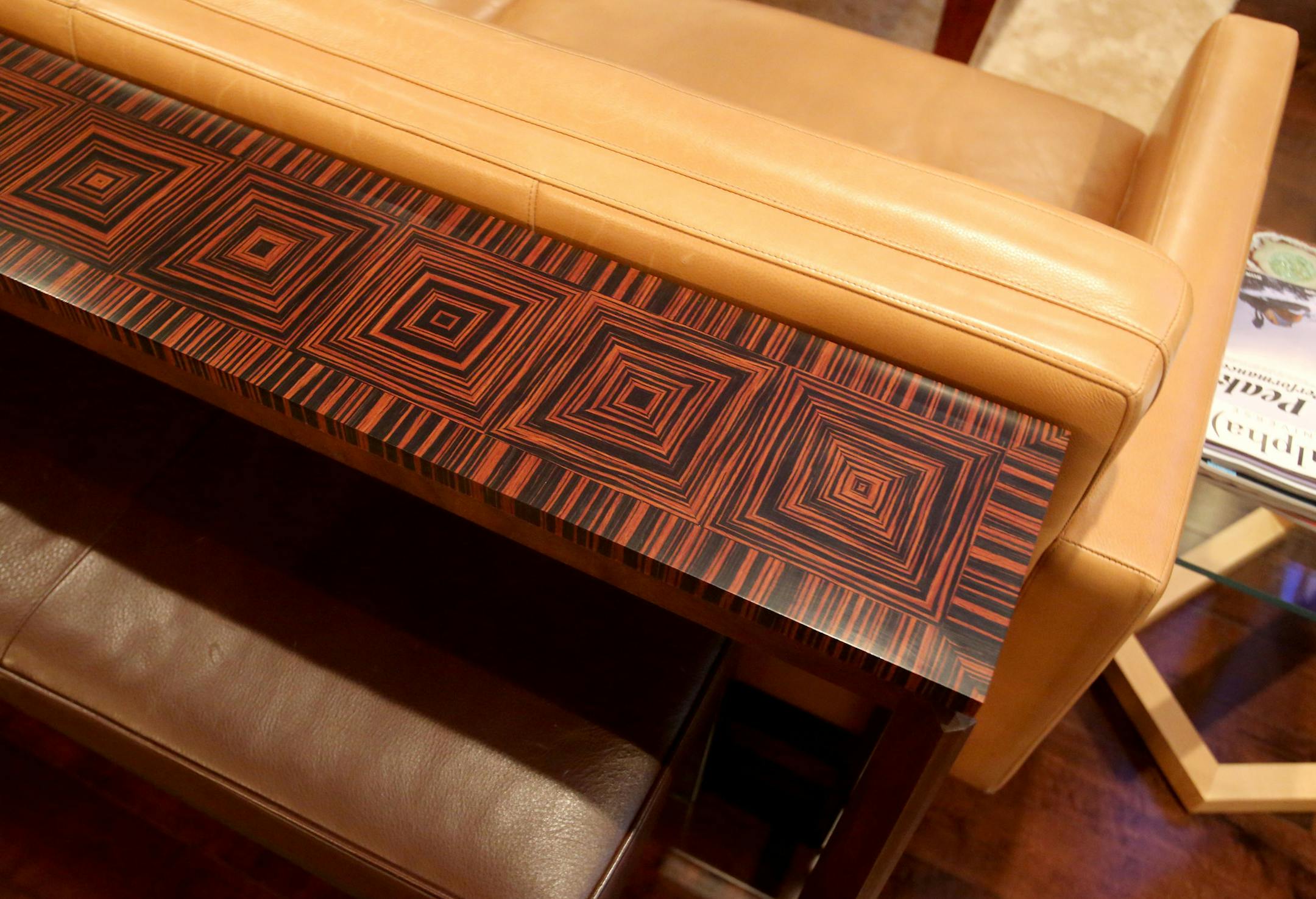 The staircase features a laser-cut metal railing designed to complement the chandelier.