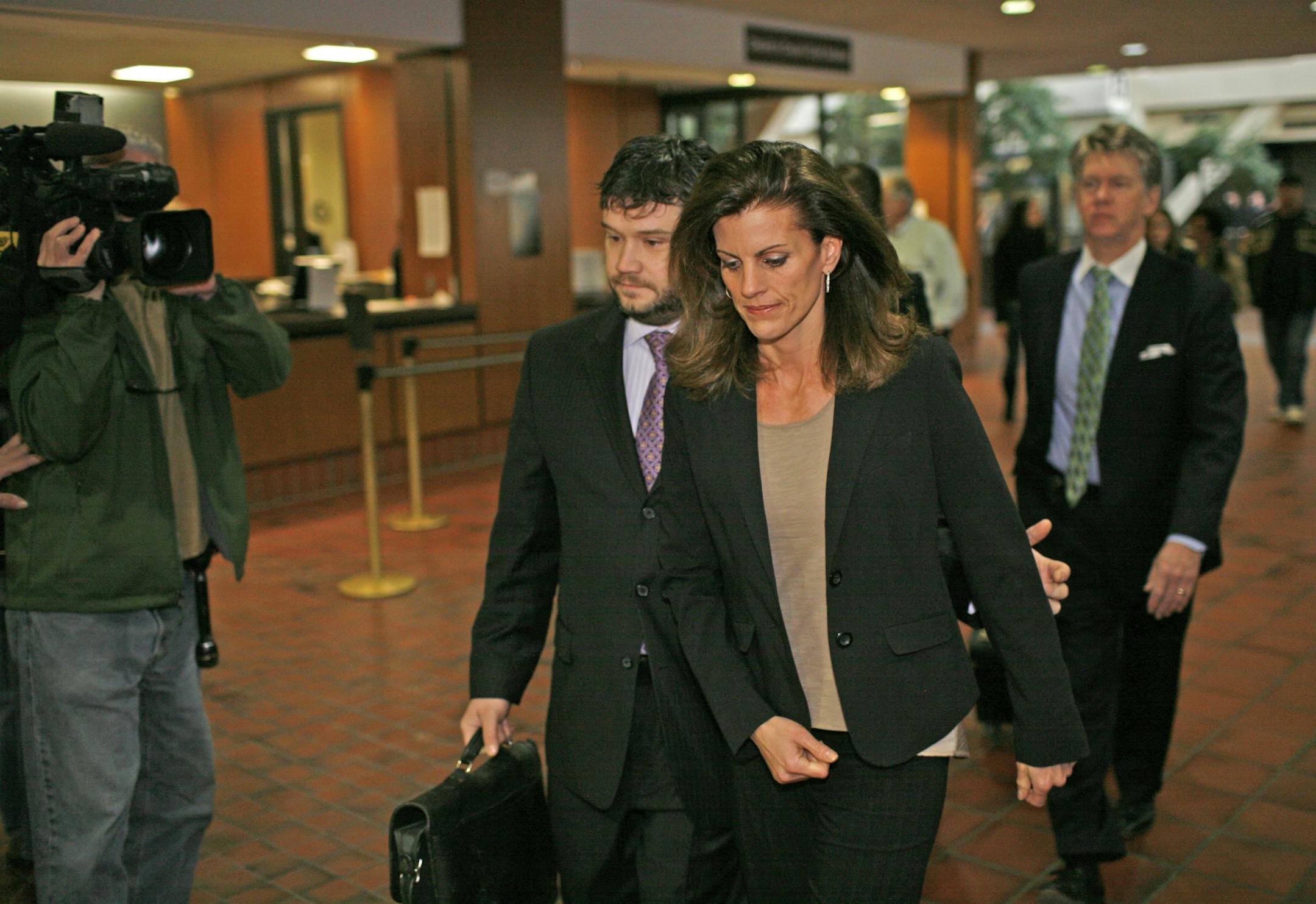 Amy Senser, center, enters the Hennepin County Government Center for a court appearance Friday, March 9, 2012. Senser attorney Eric Nelson walks right behind Senser.