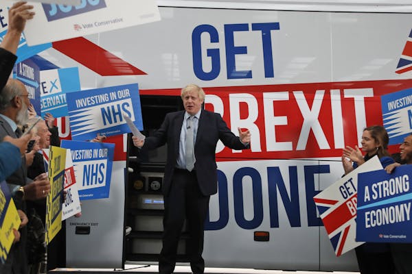 Britain's Prime Minister Boris Johnson during a General Election campaign trail stop at DPD express parcel delivery in Middleton, Manchester, England,