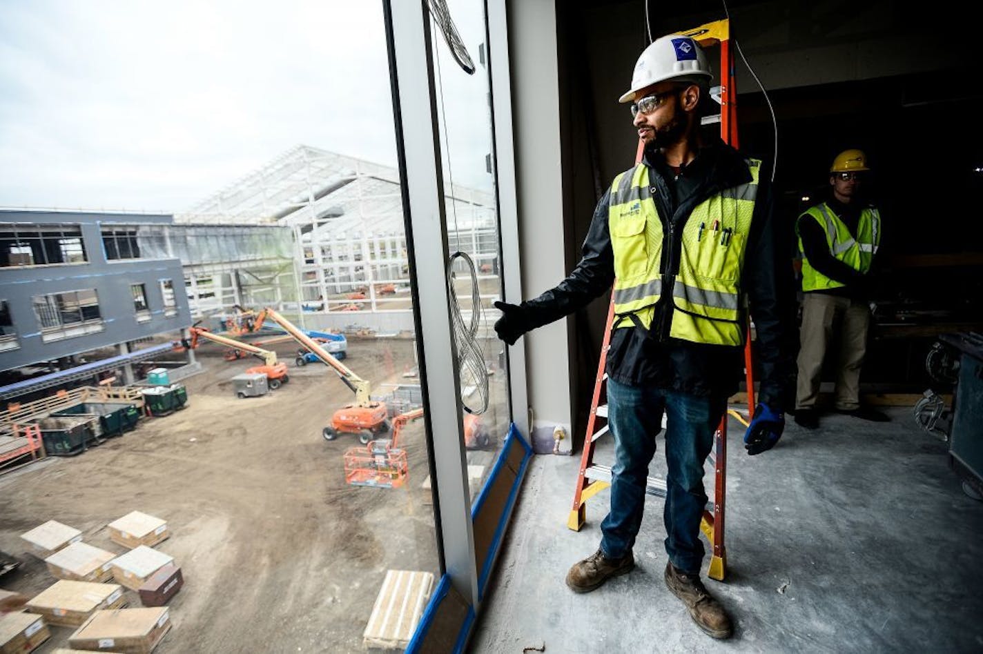 Former Gophers football player and Mortenson Field Engineer, Joe Bjorklund, looked out from office of mens' basketball coach Richard Pitino into the courtyard area of the new Athletic Village Thursday.