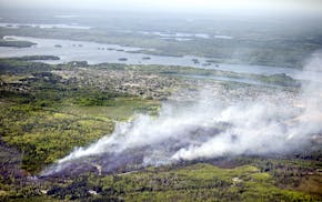 An aerial view of the wildfire that started south of Ely, Minn. Thursday May 17, 2012. A forest fire that broke out Thursday afternoon threatened the