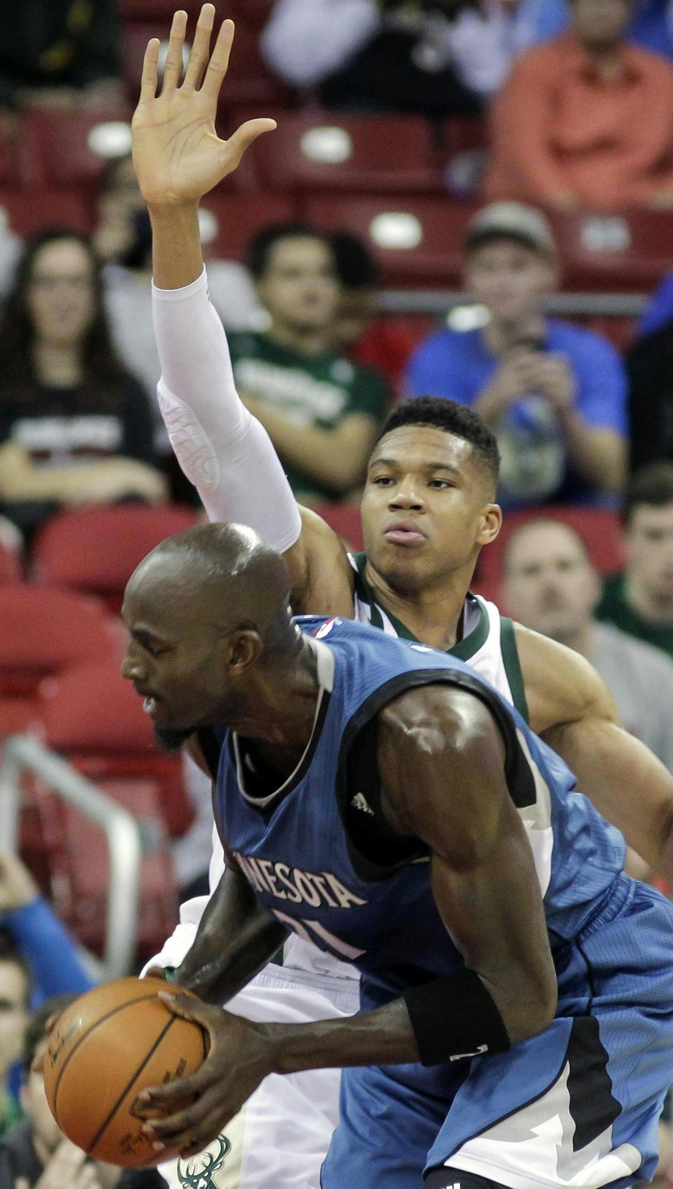 Minnesota Timberwolves' Kevin Garnett, left, drives on Milwaukee Bucks' Giannis Antekokounmpo during the first half of an NBA preseason basketball game Tuesday, Oct. 20, 2015, in Madison, Wis. (AP Photo/Andy Manis)