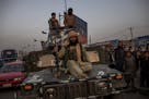 Taliban fighters on a Humvee in Kabul, Afghanistan, Aug. 15, 2021. (Jim Huylebroek/The New York Times)