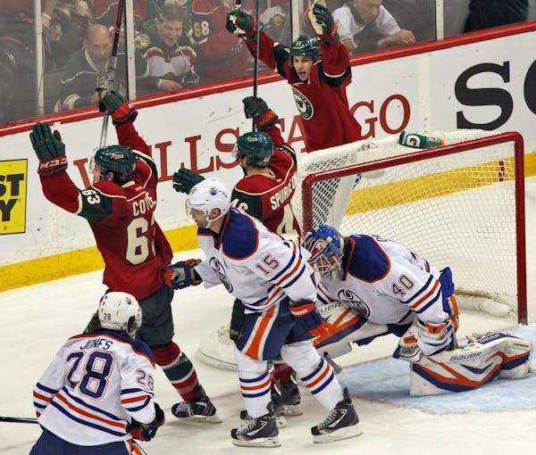 Wild players began the celebration after Charlie Coyle, left, beat Oilers goalie Devan Dubnyk for a goal.