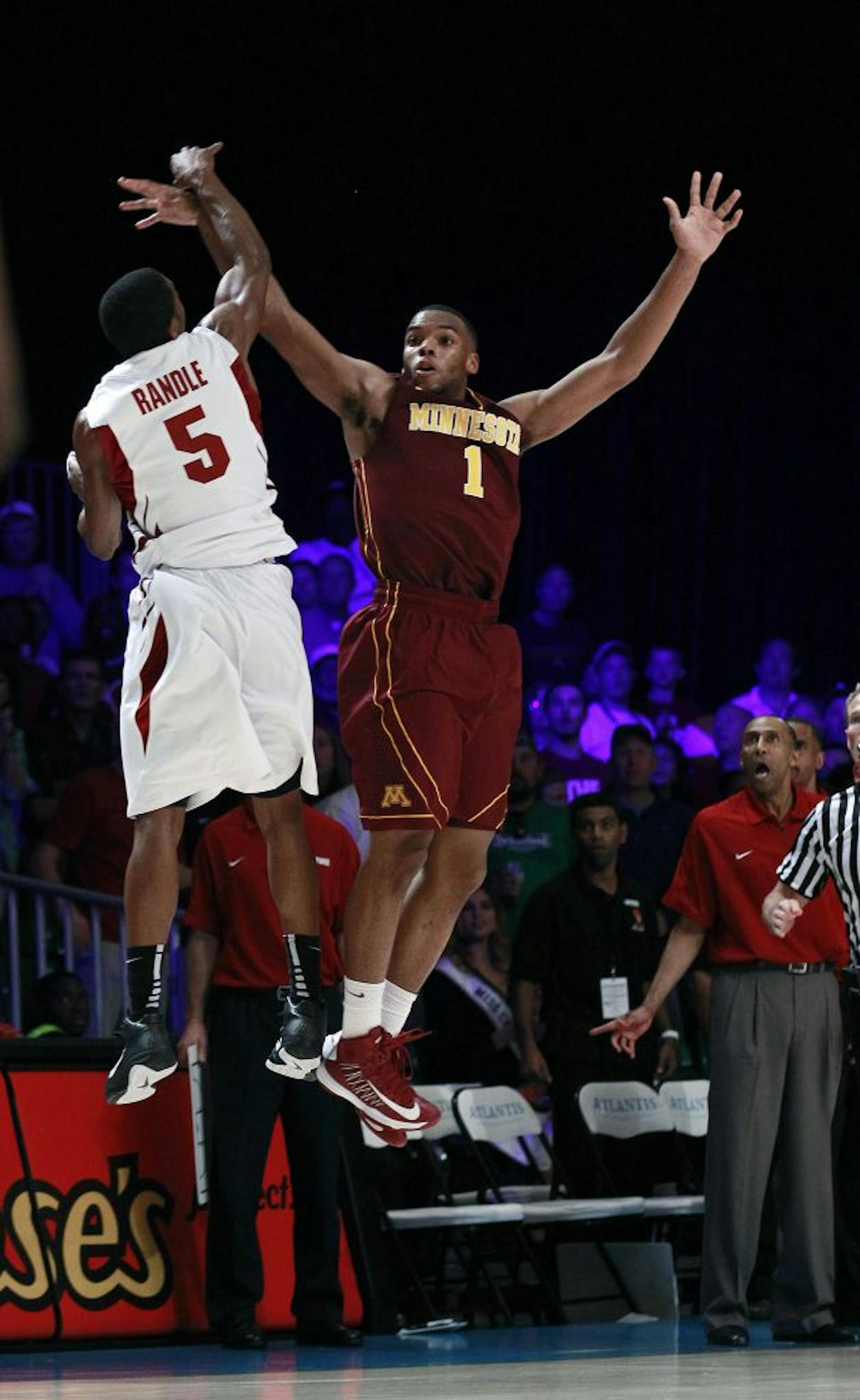 Minnesota guard Andre Hollins (1) is fouled by Stanford guard Chasson Randle (5) as he shoots a last second shot in the second half of an NCAA college basketball game at the Battle 4 Atlantis tournament Saturday, Nov. 24, 2012 in Paradise Island, Bahamas. Hollins made all of three of the free throws giving Minnesota a 66-63 victory.