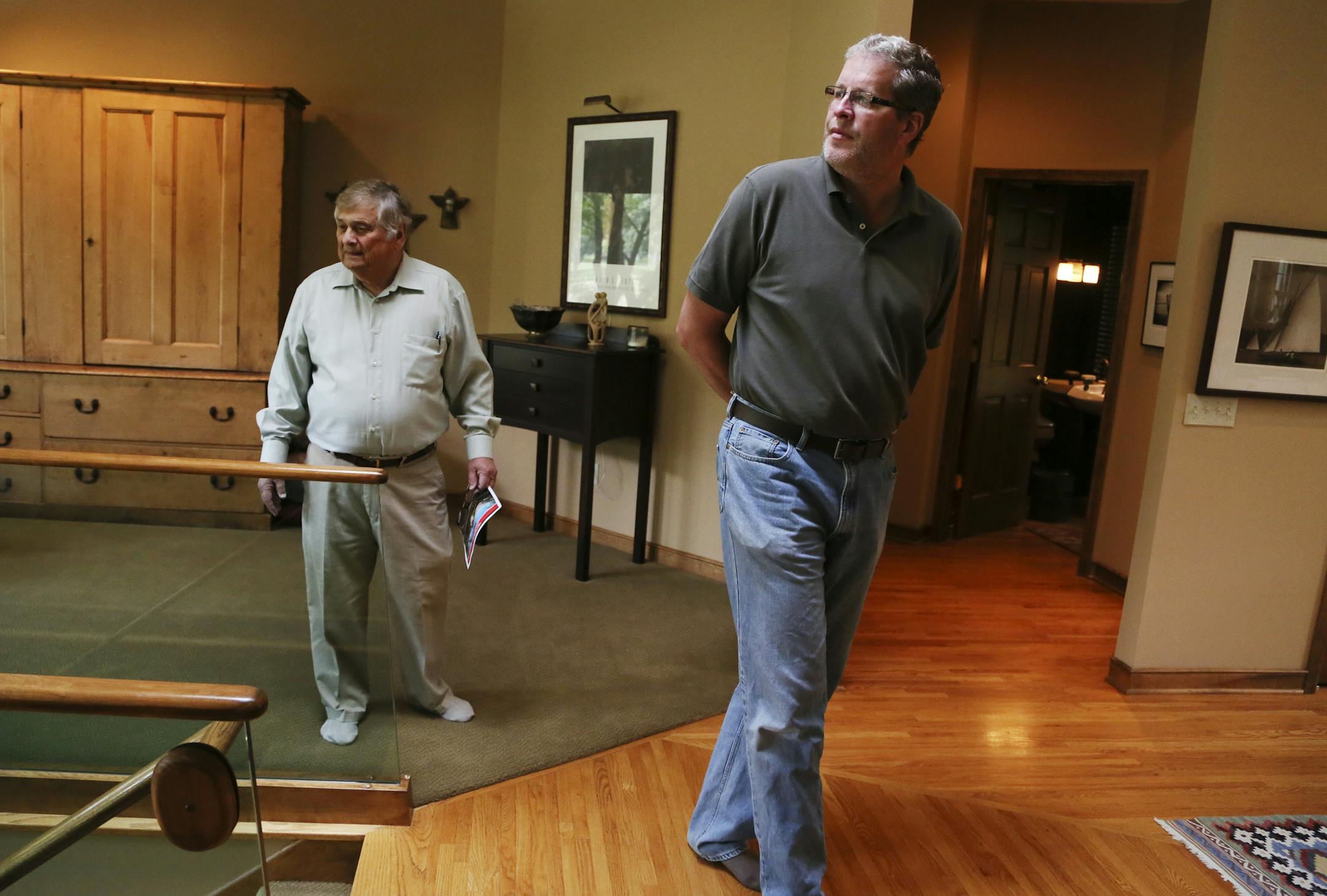 Prospective home buyer Stephen Blatnik, right, and his realtor Herb Bacal of Counselor Realty look out the livingroom window during a tour of a four bedroom, four bath home in Edina overlooking Mirror Lake at a realtor's open house Tuesday, Sept. 17, 2013, in Edina, MN. The home was on the market for $999,900. "For under a million (dollars) it's a great buy," Meg Meyers, Edina Realty realtor senior analyst, who represented the sellers, had said earlier in the day.](DAVID JOLES/STARTRIBUNE) djole