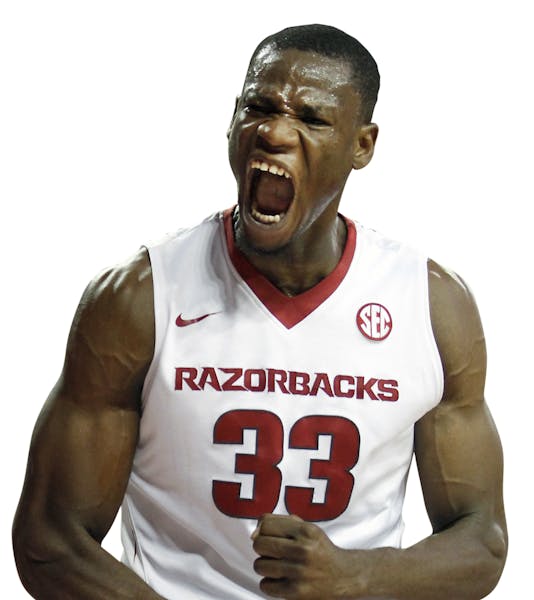 FILE - In this Nov. 13, 2015, file photo, Arkansas' Moses Kingsley (33) shouts after dunking the ball during the second half of an NCAA college basket