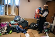 Salvation Army Auxiliary Capt. Joshua Polanco sorts through donated coats on Monday at the Noble Worship and Service Center in Brooklyn Park. A cleani