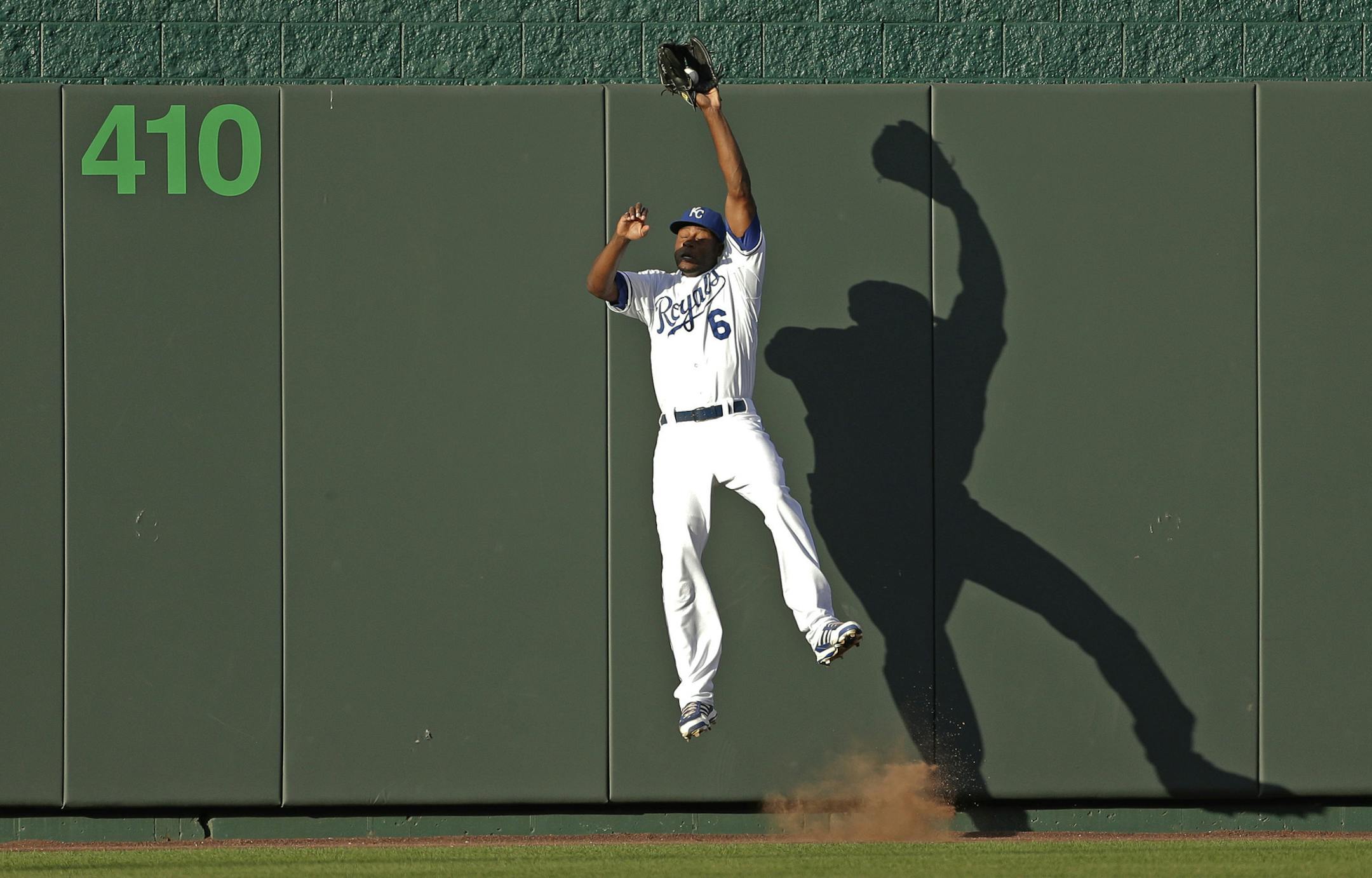 Kansas City Royals center fielder Lorenzo Cain catches a fly ball for the out on Detroit Tigers' Torii Hunter during the first inning of a baseball game, Friday, July 19, 2013, in Kansas City, Mo. (AP Photo/Charlie Riedel)