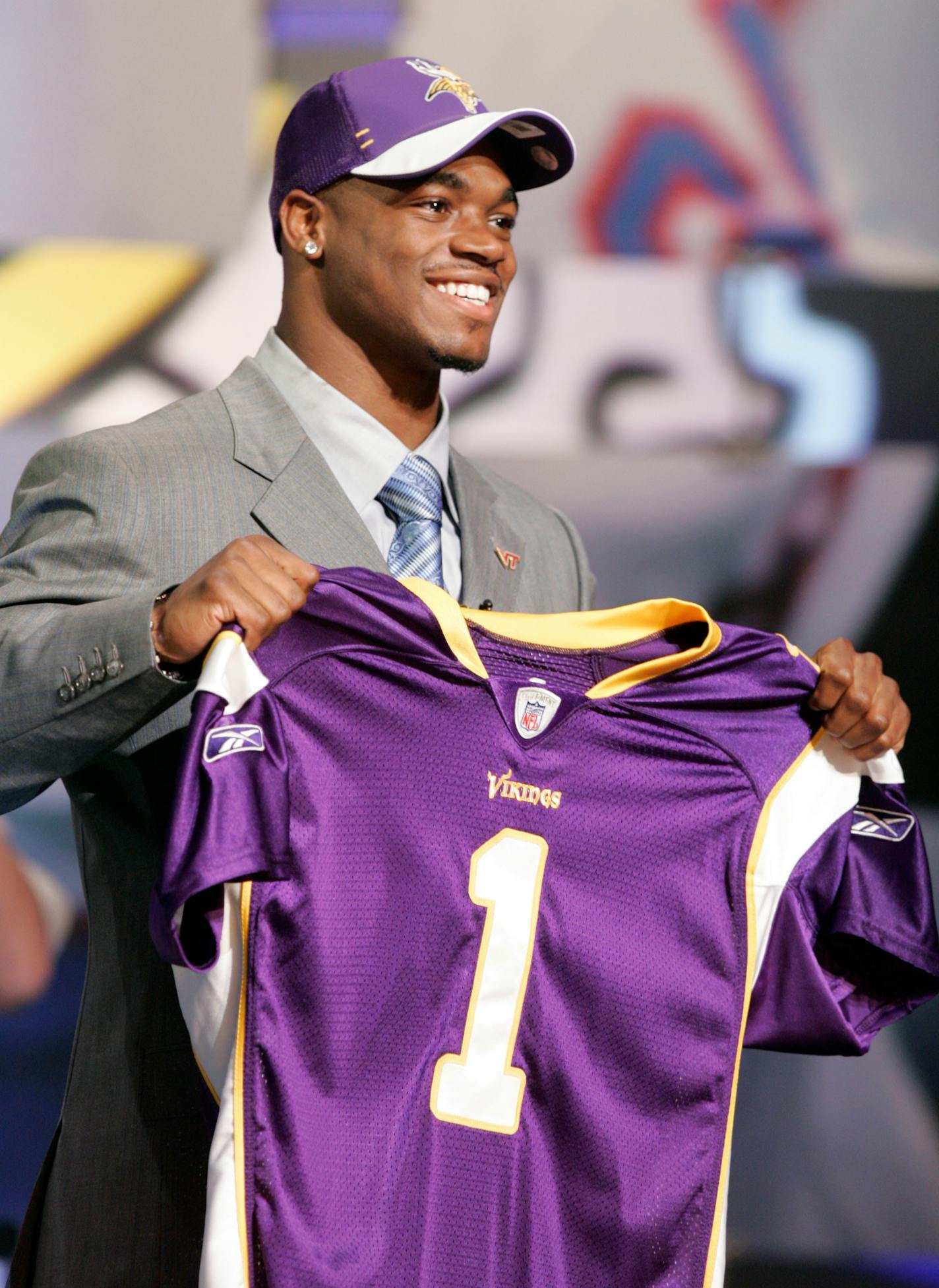 Adrian Peterson, a running back from Oklahoma, smiles while holding a jersey after being selected seventh overall by the Minnesota Vikings in the first round of the NFL Draft Saturday, April 28, 2007 at Radio City Music Hall in New York. (AP Photo/Frank Franklin II) ORG XMIT: NYFF131