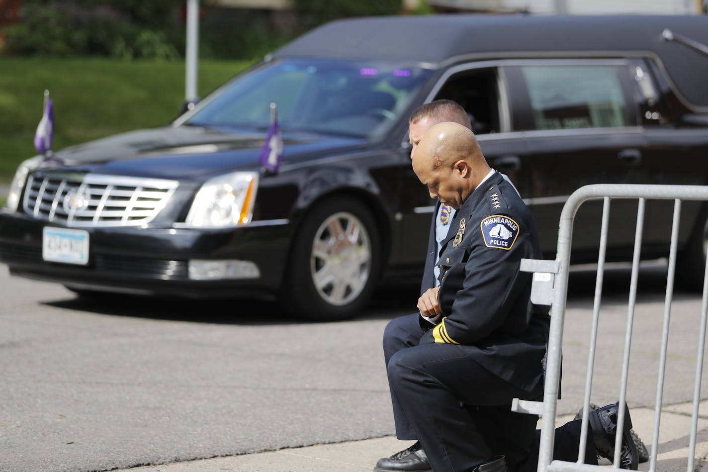 Police officers including Minneapolis Police Chief Medaria Arradondo, foreground, took a knee as the body of George Floyd arrived before his memorial services in Minneapolis on June 4.