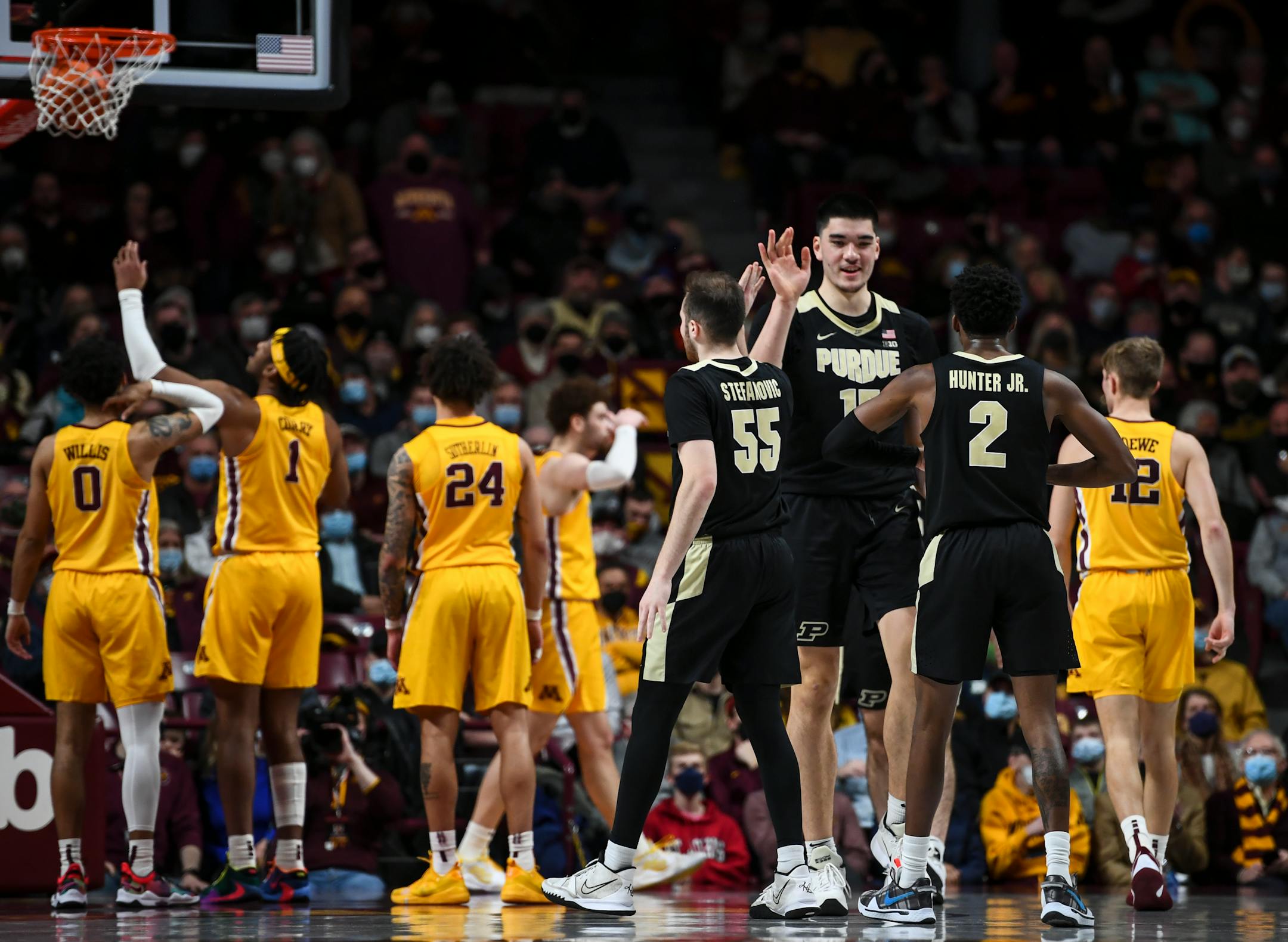 Purdue Boilermakers center Zach Edey (15) celebrates with teammates after drawing a foul from Minnesota Gophers forward Eric Curry (1) for an and one during the first half of an NCAA men's basketball game between Minnesota and Purdue at Williams Arena in Minneapolis, Minn.