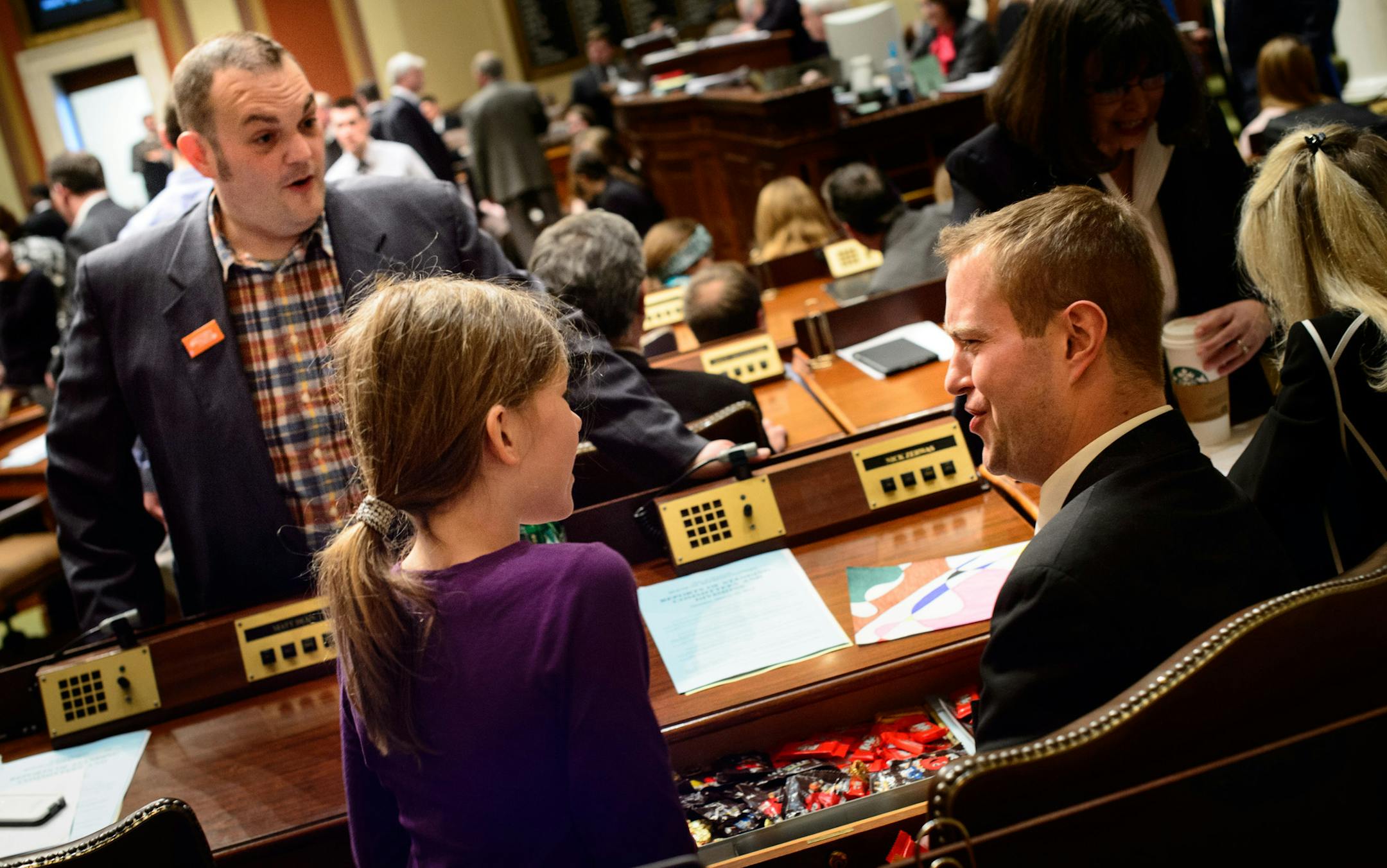 Rep. Nick Zerwas, R-Elk River, offered Addie Schoen, 8, something from his candy stash before the start of Monday’s session. Addie was on spring break and got to come to work with her dad, Rep. Dan Schoen, DFL-St. Paul Park.