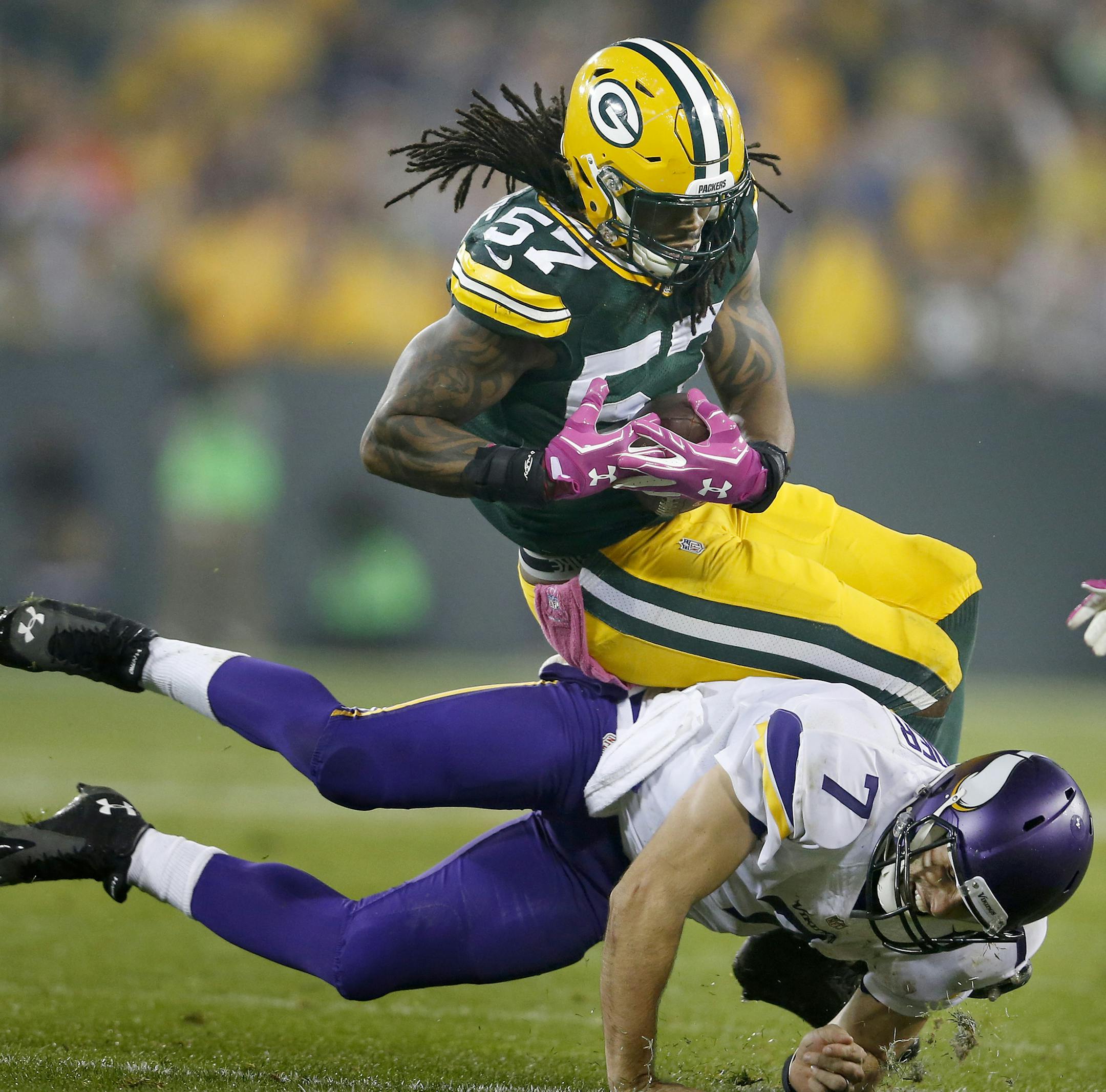 Jamari Lattimore (57) was tackled by Christian Ponder (7) after he intercepted a Ponder pass in the second quarter. ] CARLOS GONZALEZ cgonzalez@startribune.com - October 2, 2014 , Green Bay, WI NFL, Lambeau Field, Minnesota Vikings vs. Green bay Packers
