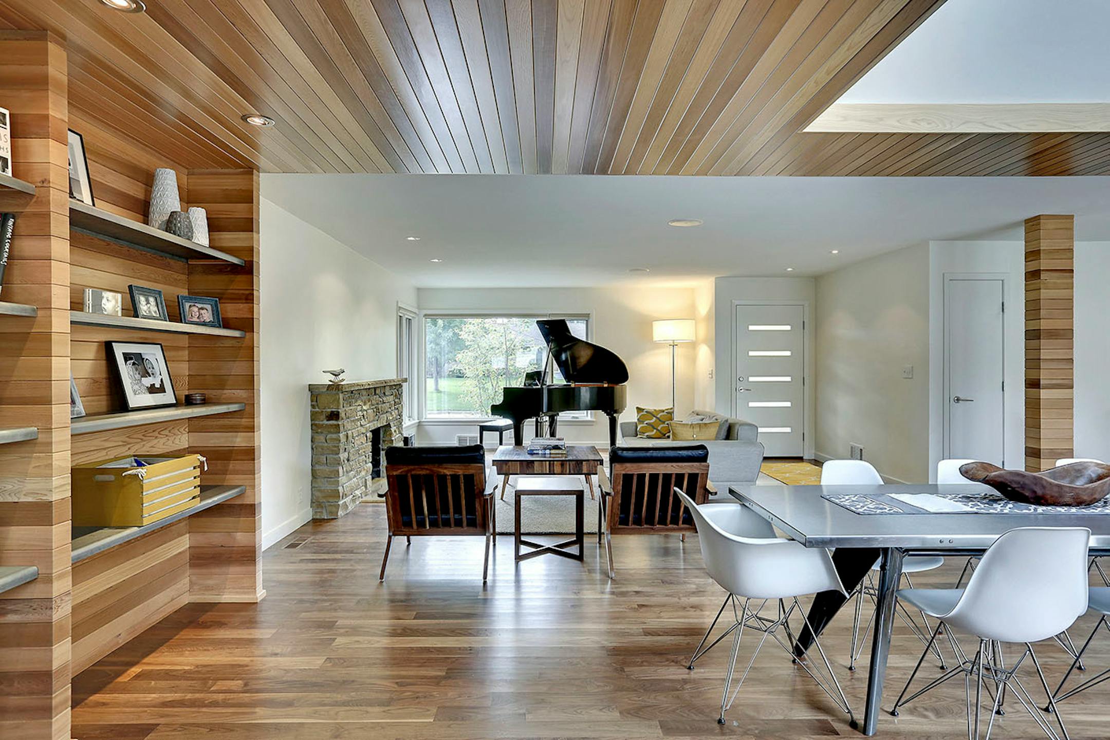 The 1950s rambler's revamped open spaces are accented with a palette of steel and wood, transforming the plain-Jane house into a cool midcentury modern abode.