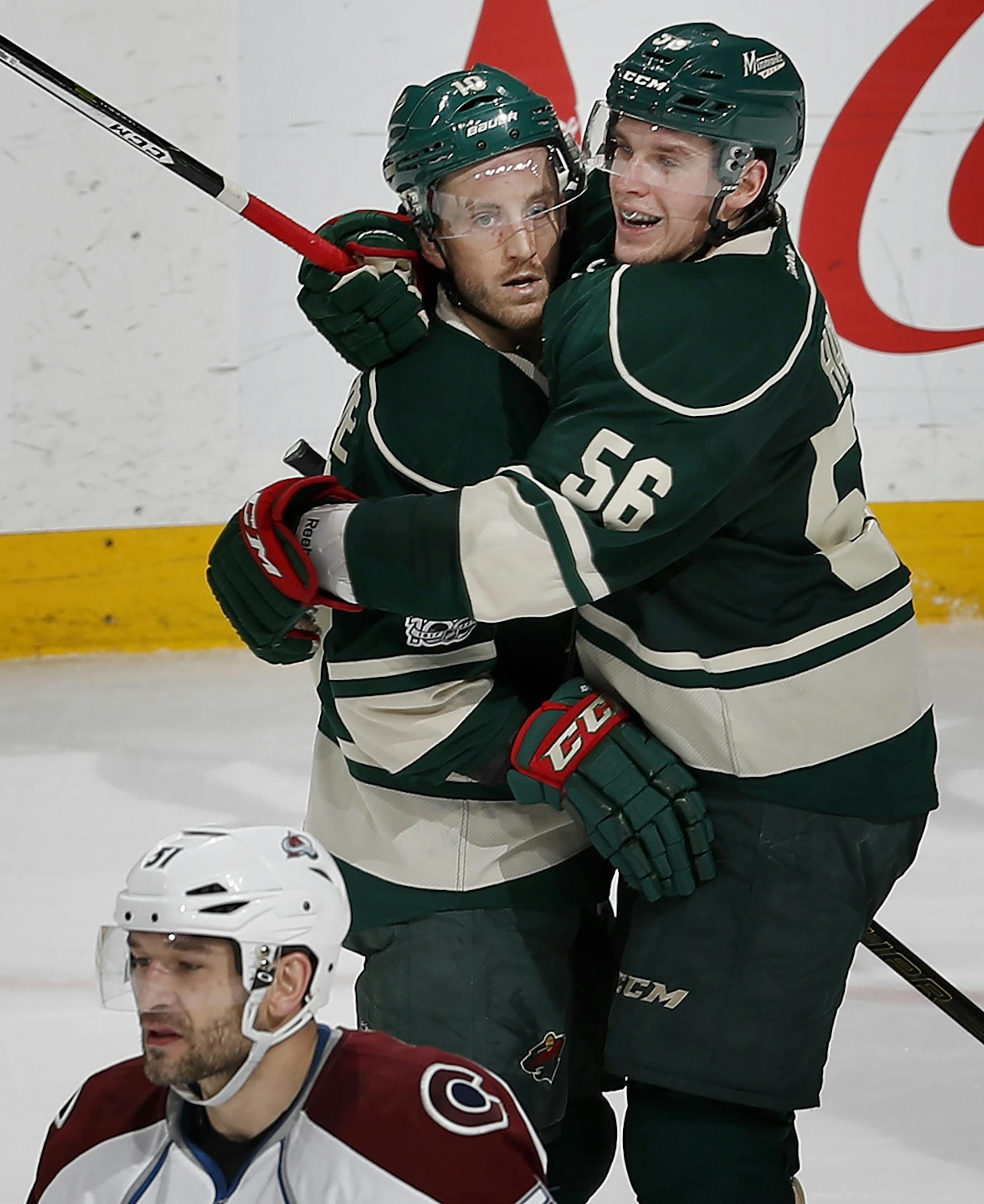 Jordan Schroeder (10) celebrated with Erik Haula (56) after scoring a goal in the second period.