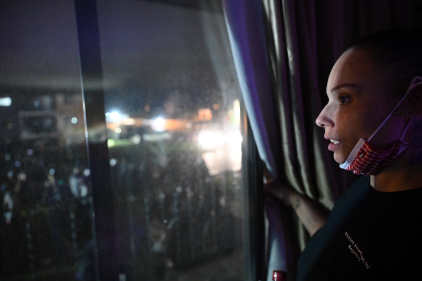 Angela Johnson, a resident across street from police department, watches chaos from her window. SheÕs been trying to study psychology and wants to be an addiction counselor. People were protesting near the Brooklyn Center Police Department in response to the fatal police shooting of Daunte Wright, Wednesday, April 14, 2021 in Brooklyn Center, Minn. Former Brooklyn Center police officer Kimberly Potter was charged with second degree manslaughter after the shooting. ] AARON LAVINSKY ¥ aaron.lavinsky@startribune.com