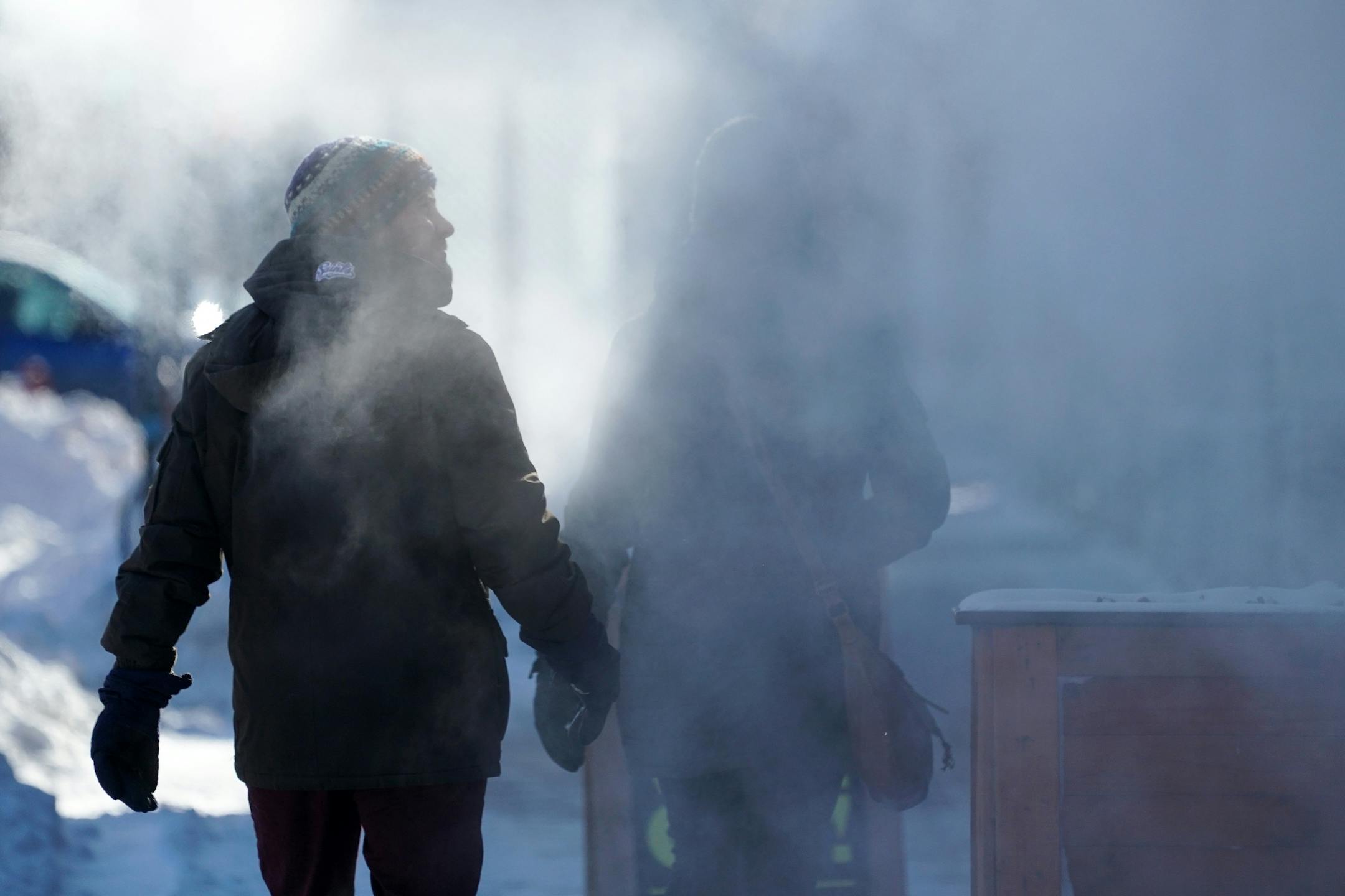 A couple walked past steam coming from a building on Lyndale Avenue South in Minneapolis.