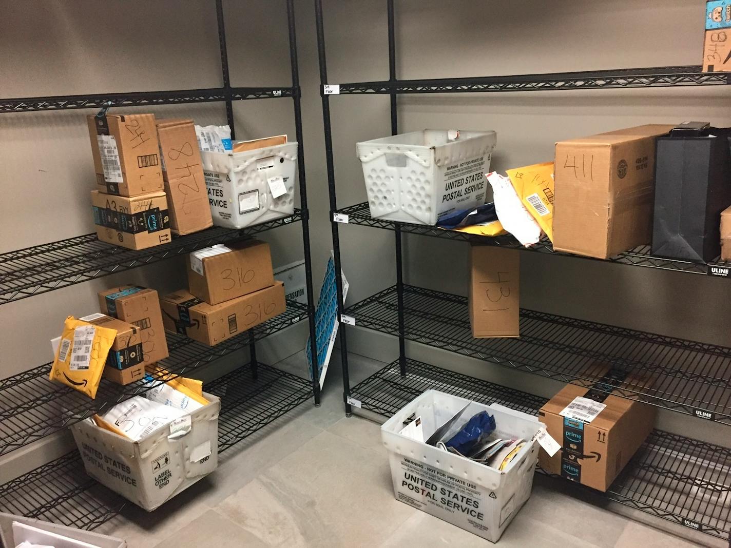 In this April 13, 2018, photo, packages from Internet retailers are delivered with the U.S. Mail in a apartment building mail room in Washington. Clicking "checkout" on an online purchase could cost more after a Supreme Court case being argued April 17.