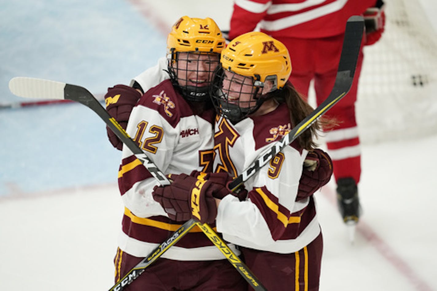 Minnesota Golden Gophers forward Grace Zumwinkle (12) was mobbed by Minnesota Golden Gophers forward Taylor Heise (9) after she scored the Gophers third goal of the game in the third period. ] ANTHONY SOUFFLE • anthony.souffle@startribune.com