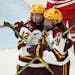 Minnesota Golden Gophers forward Grace Zumwinkle (12) was mobbed by Minnesota Golden Gophers forward Taylor Heise (9) after she scored the Gophers thi