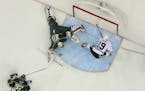 Wild goalie Devan Dubnyk (40) with a first period save of a breakaway shot by the Blackhawks' Jonathan Toews (19) Tuesday night. ] JEFF WHEELER � je