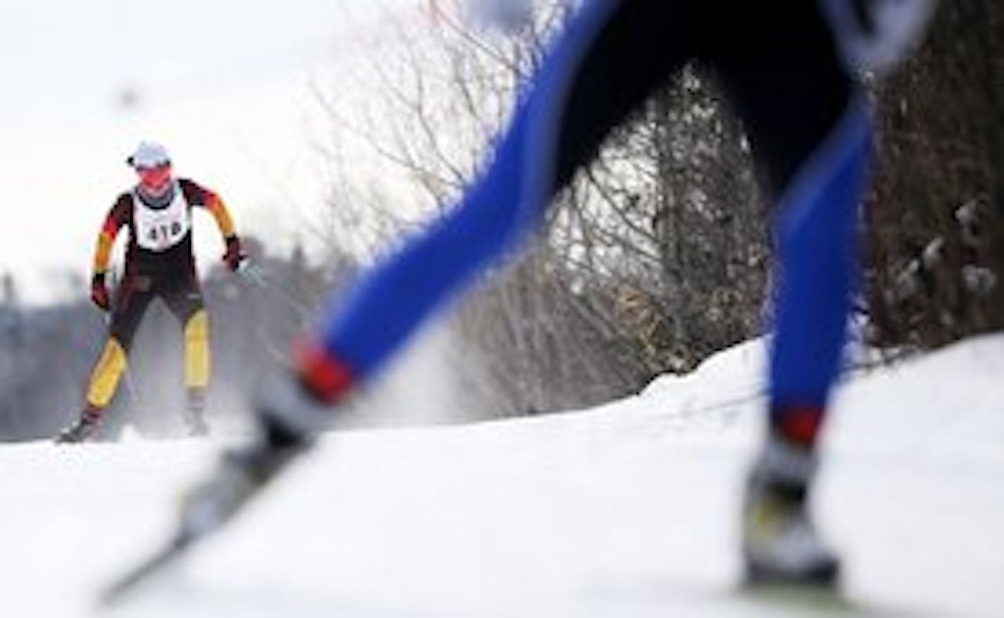 Eastview senior Margie Freed, left, chased a skier during the girls' 5K freestyle in the Nordic skiing state meet. She won her first pursuit title Thursday by nearly 15 seconds at Giants Ridge.