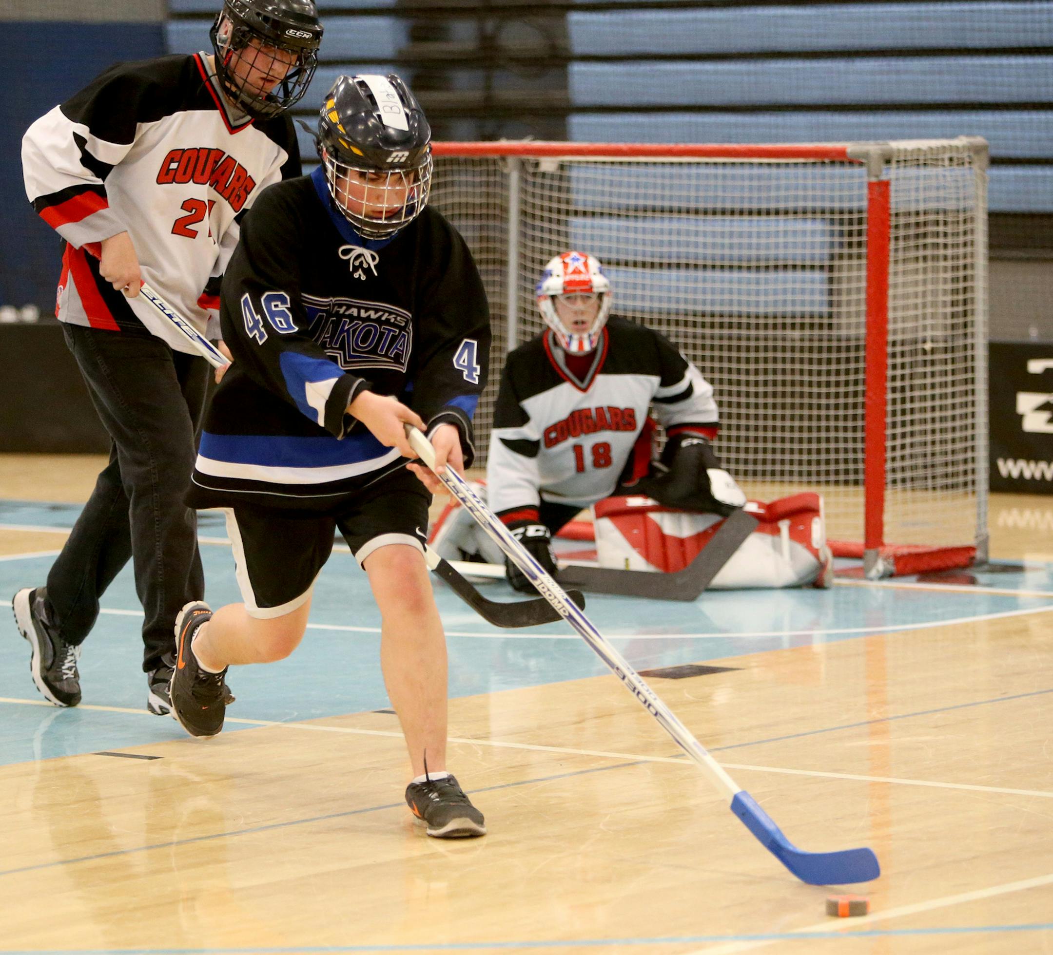 Dakota United won 4-2 over North Suburban during the adapted floor hockey CI championships at Bloomington Jefferson High Saturday, March 14, 2015, in Bloomington, MN. Here, Dakota United's Blake St. Mane (46) chases down a puck, past North Suburban's Keven Beaupre (24) during second period action. ](DAVID JOLES/STARTRIBUNE)djoles@startribune.com Adapted floor hockey championships