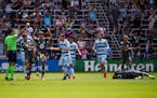 Minnesota United midfielder Emanuel Reynoso (10) lay injured last Saturday after a red card foul by Sporting Kansas City’s Remi Walter (54).