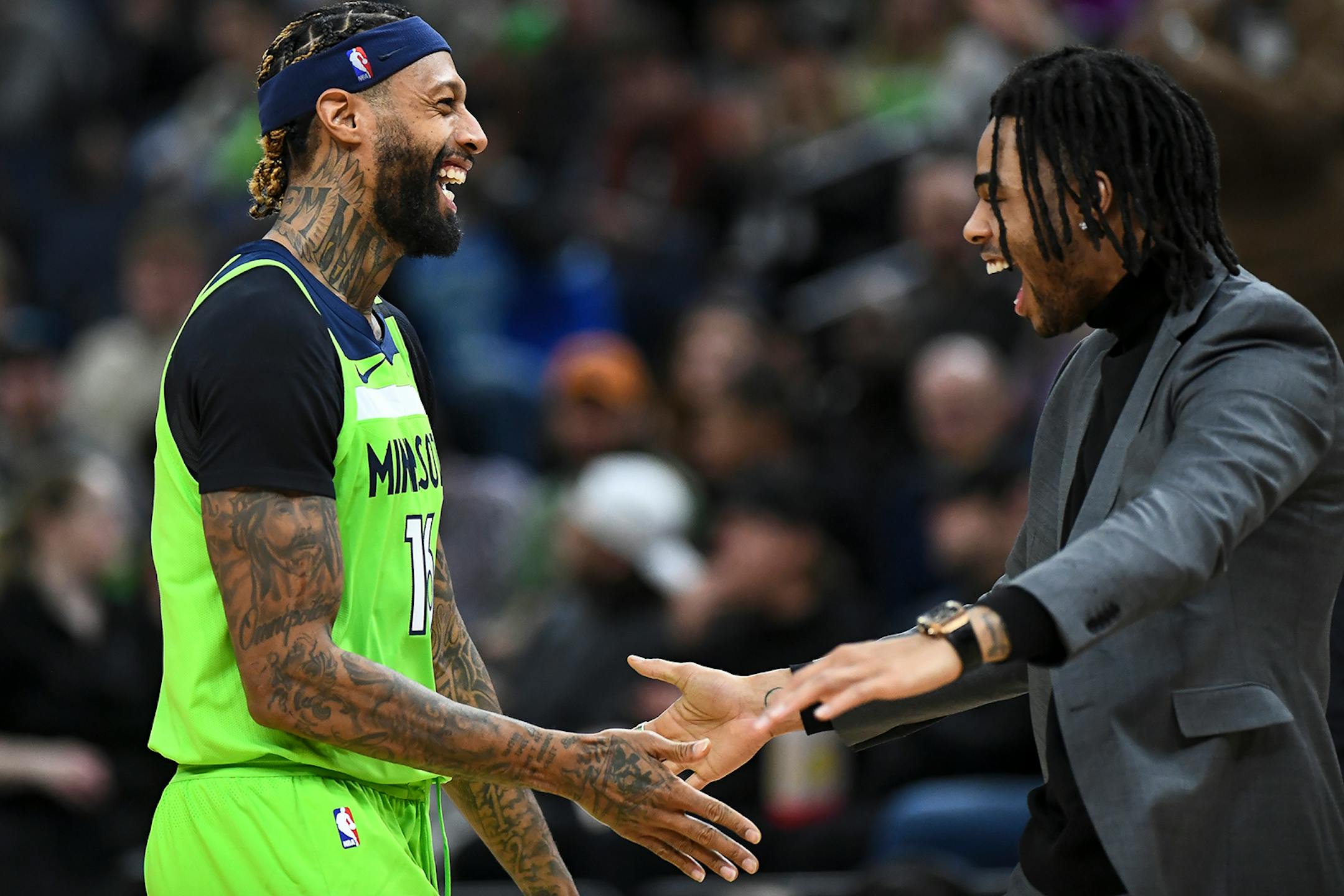 Minnesota Timberwolves forward James Johnson (16) celebrated with guard D'Angelo Russell (0) after a basket scored by Johnson in the second half.
